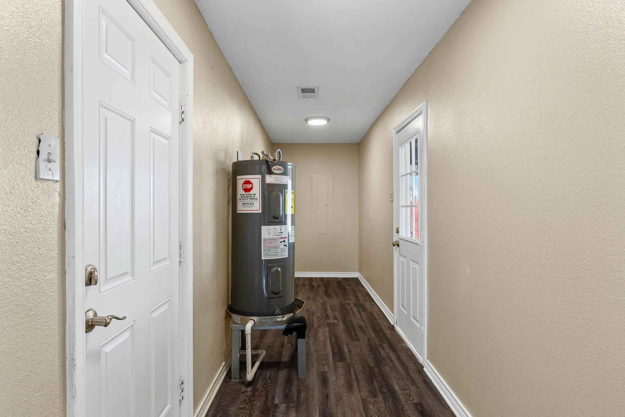 Laundry room with back door and door to carport