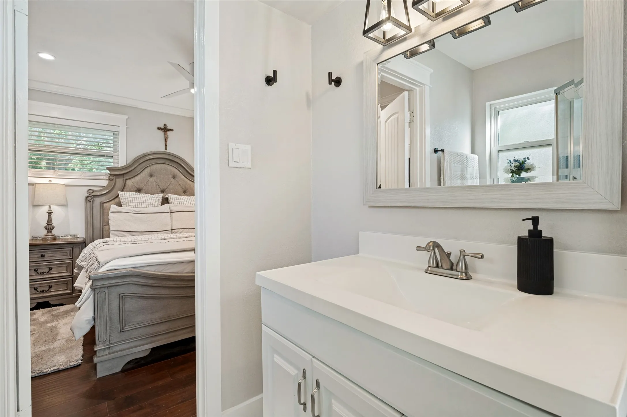 White vanity with an integrated sink and brushed nickel faucet