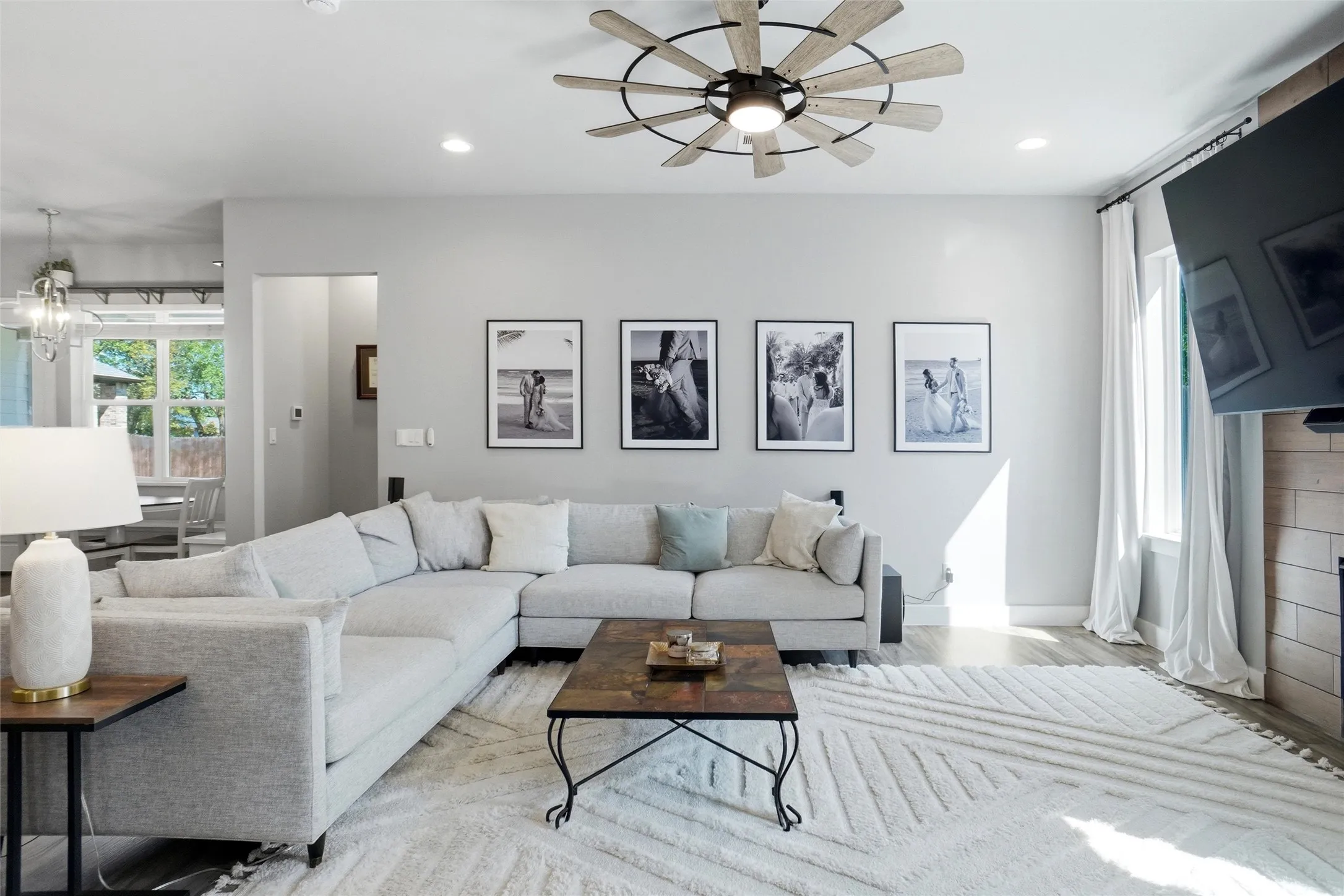 One last view of the living  room looking towards the rear of the home.  To the left you can see the breakfast area. Also the crisp delineation between the soft paint color and the trim offers a serene feel.