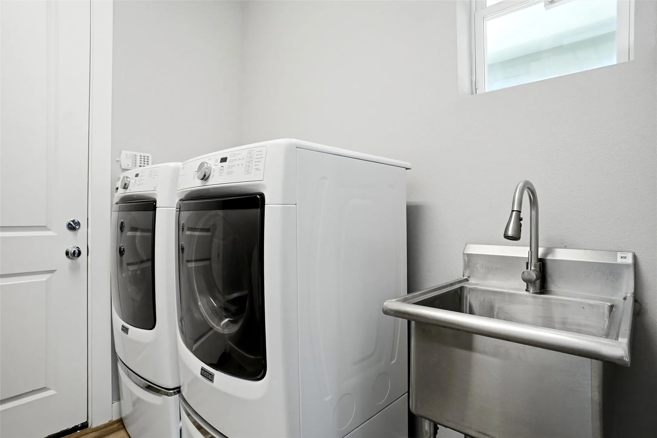 The utility room is full size with a huge stainless steel sink.   This is a perfect place to bathe and groom your pups!
The home also has a TANKLESS water heater.