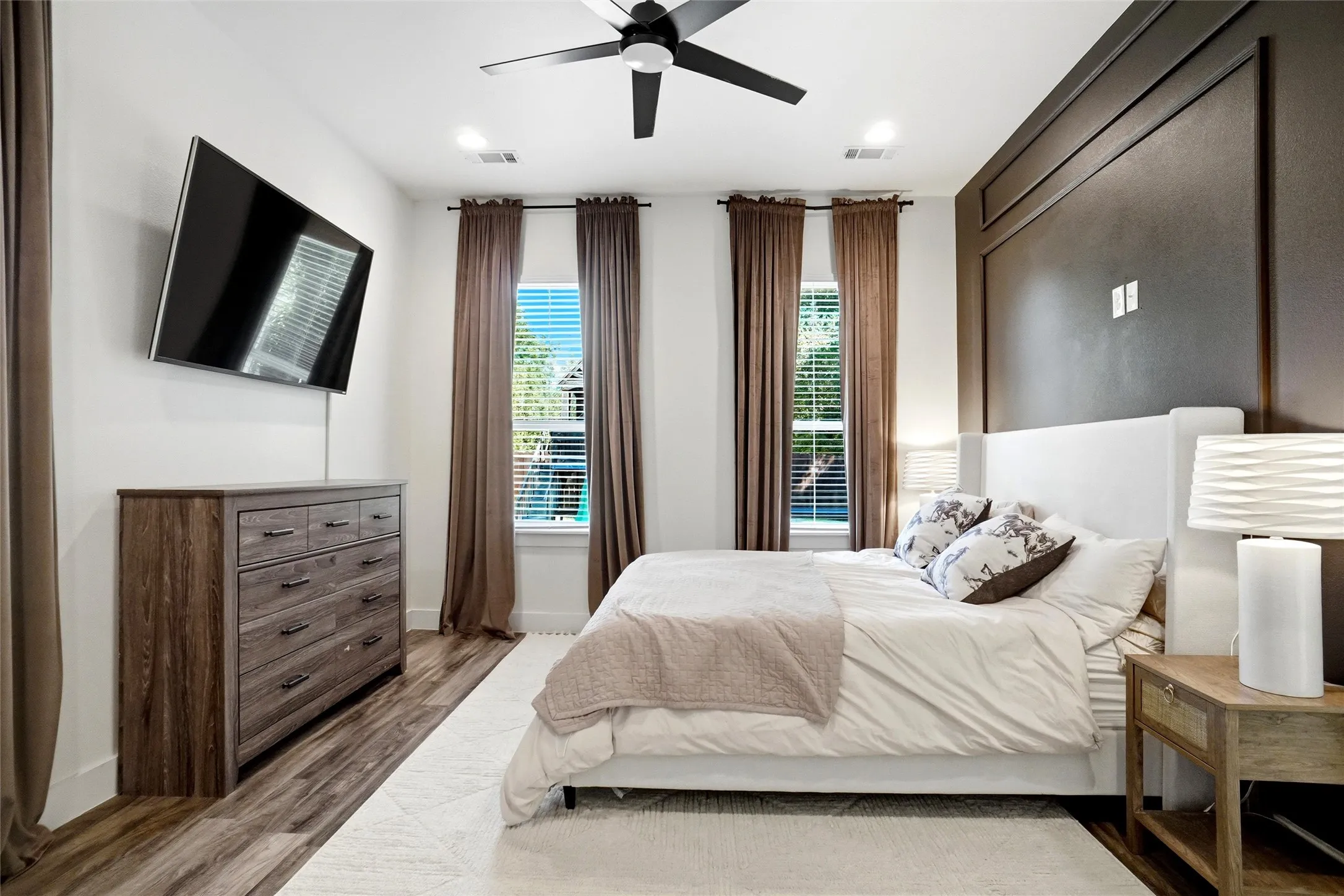 Here is the master bedroom with a tall ceiling and views to the rear yard. A nice open area for your furniture placement.