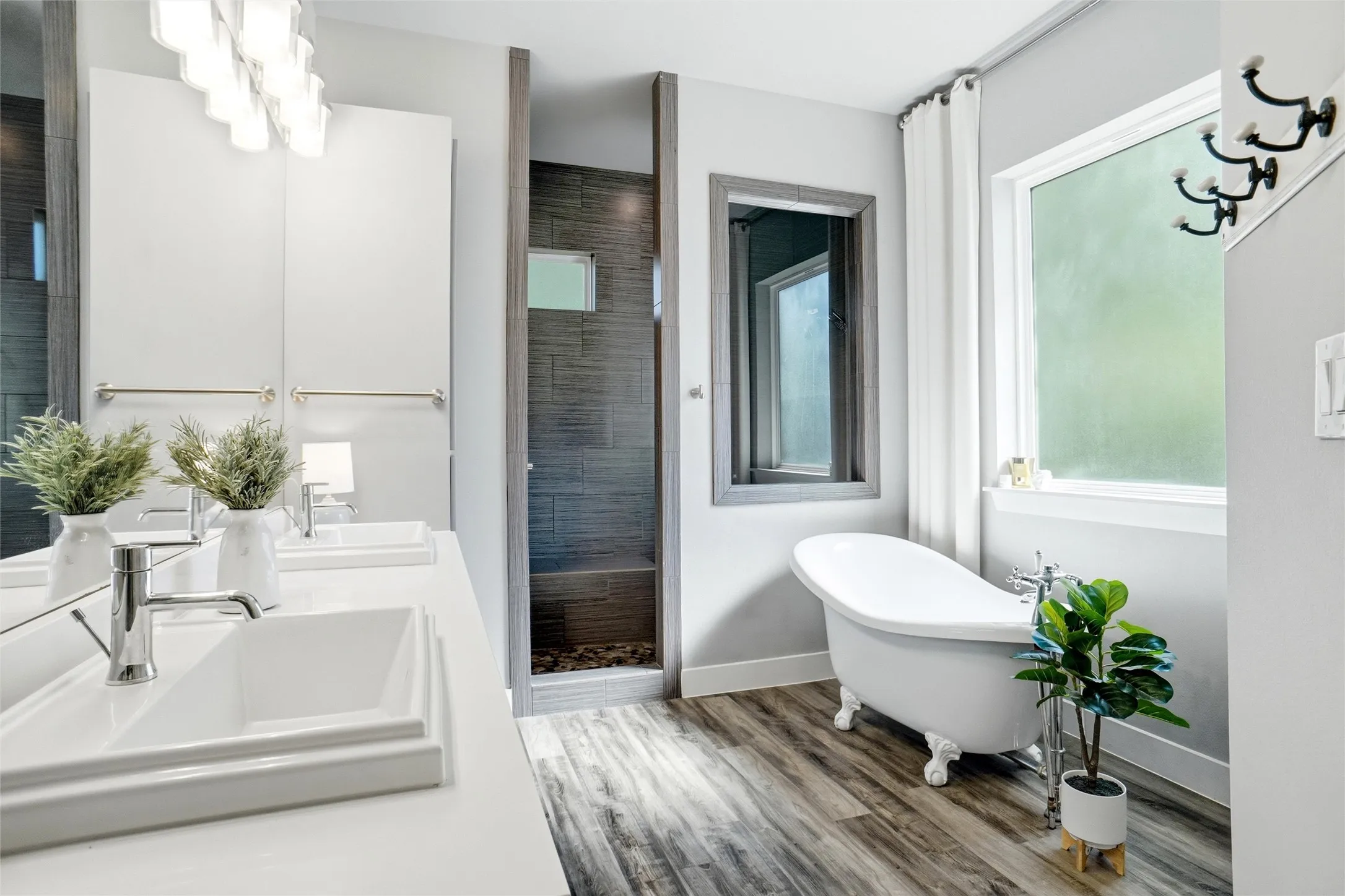 The bathroom is so nice and airy, a pleasure to awaken to each morning! You can see the oversized dual sink vanity and the claw foot tub (looks small in the photo...but certainly not in person, it is just a large room). Also note the  oversized shower in the background.