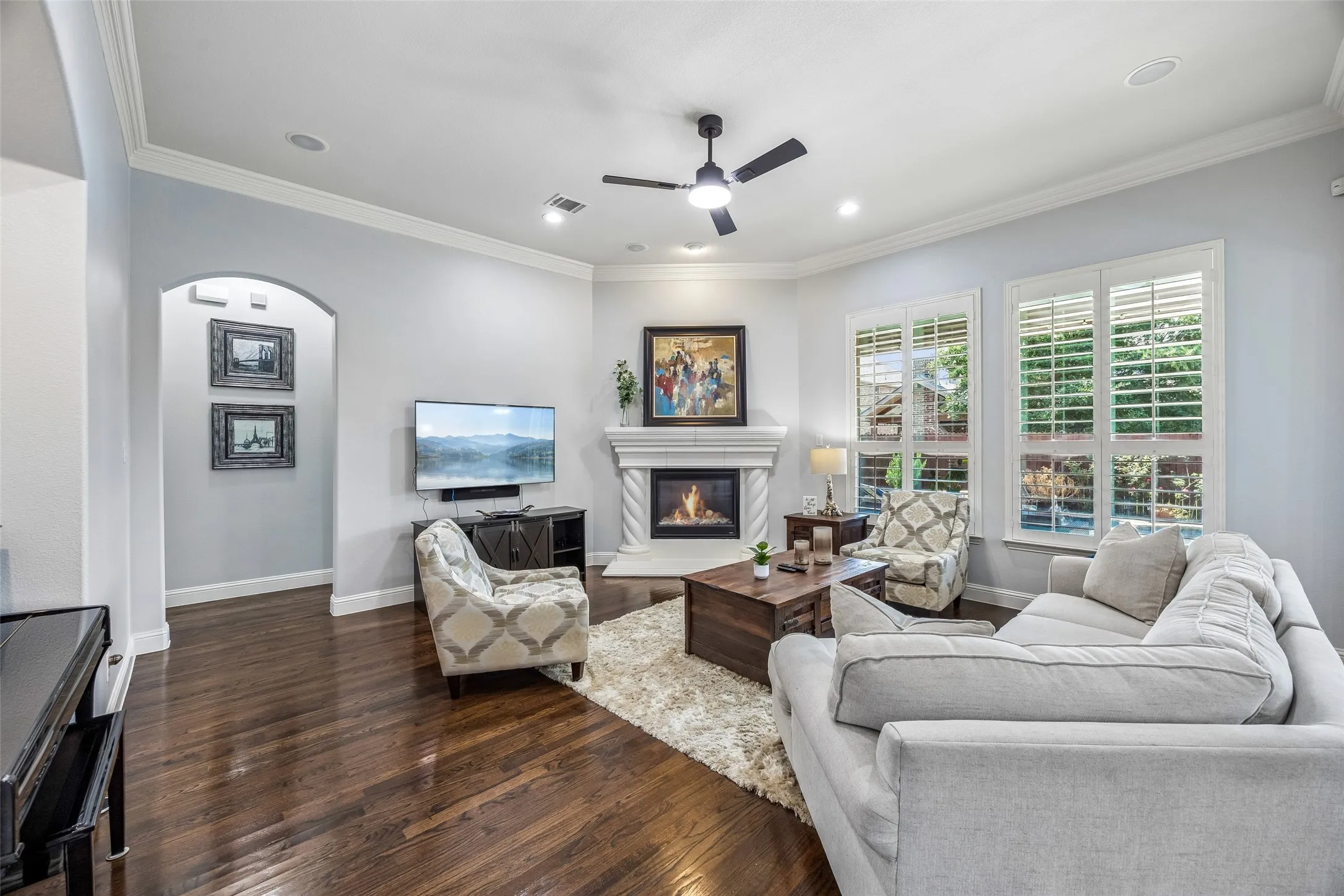 Cozy living room features a stone fireplace and nook for a piano