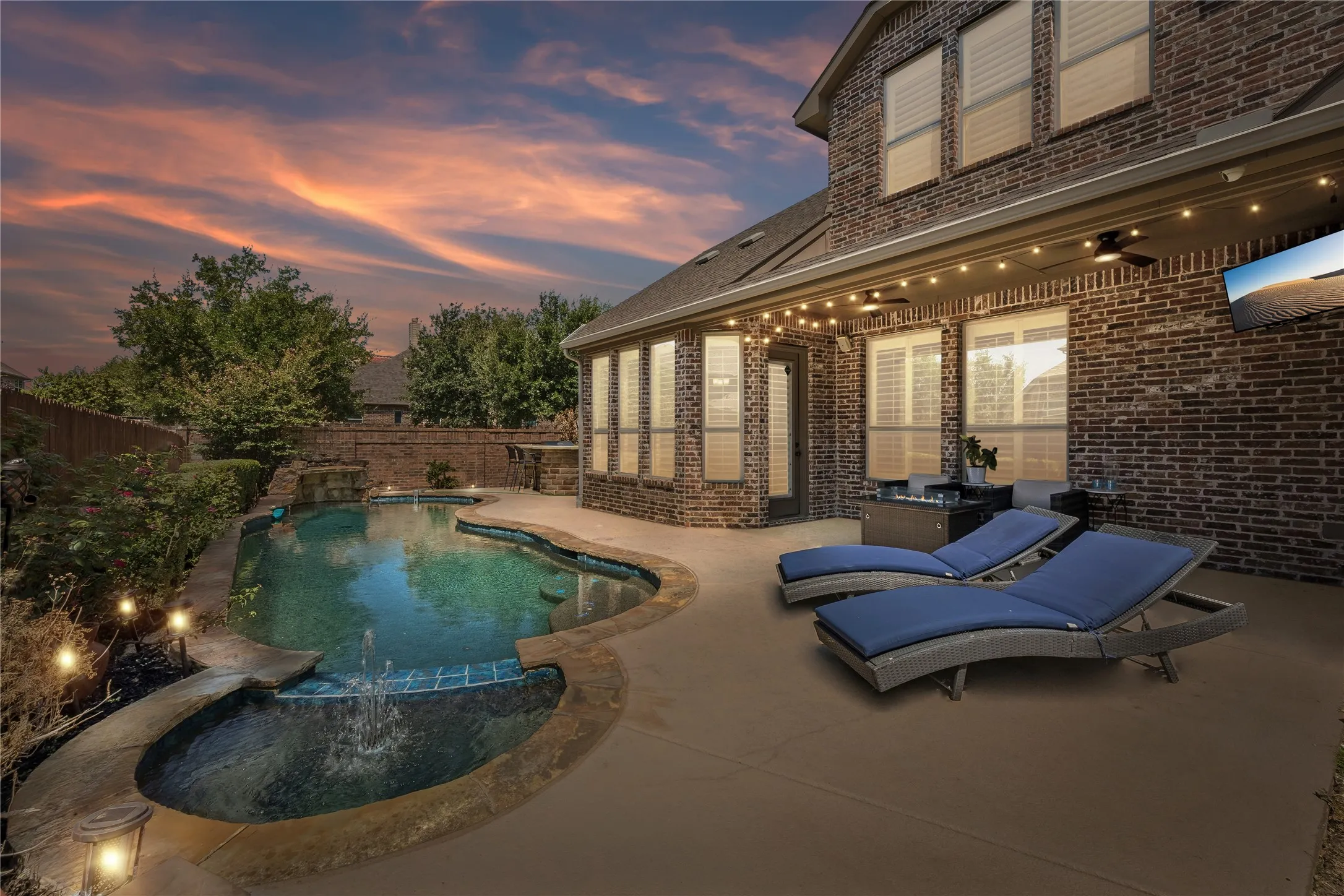 Gorgeaus landscaped backyard features outdoor kitchen and saltwater pool