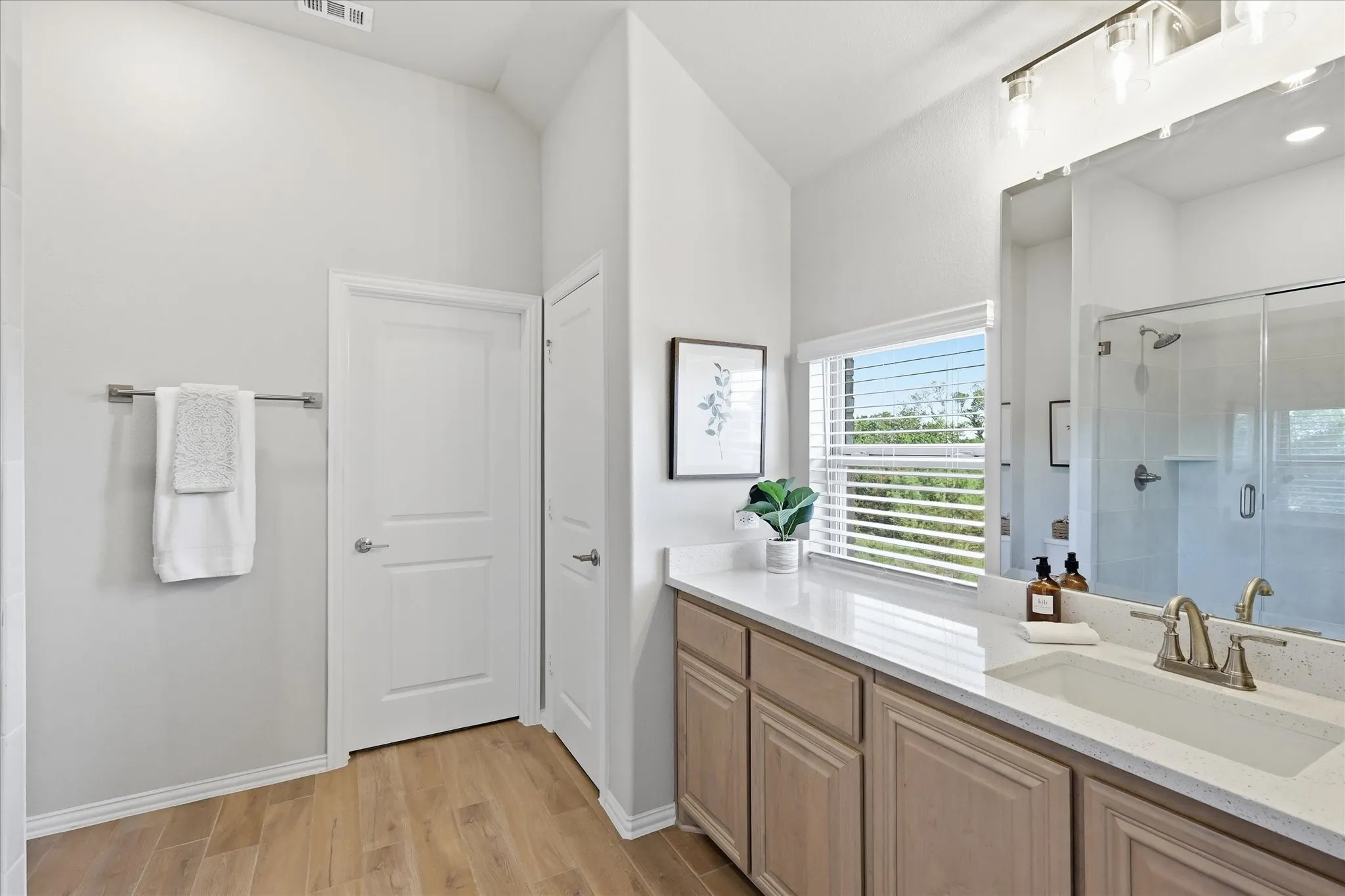 Second primary bathroom with massive shower, large vanity and plenty of counterspace, upgraded countertops and walk in closet!