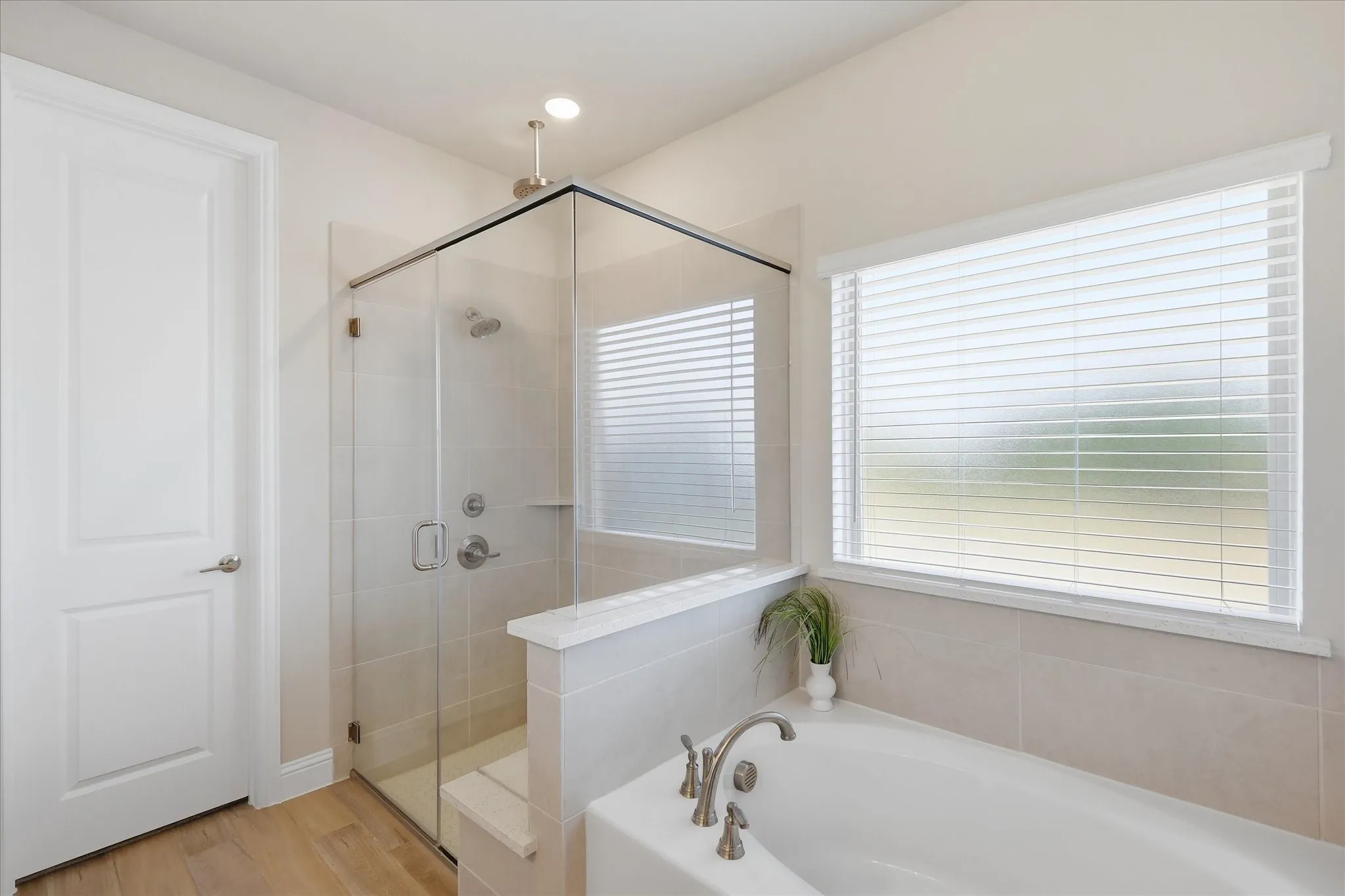 1st floor primary ensuite bath featuring a soaking tub, seperate shower with rainfall head, dual sinks, great vanity and walk in closet!