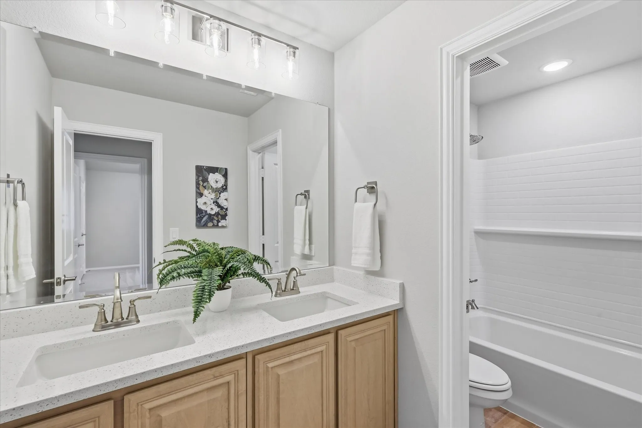Dual vanity with light-tone cabinetry and a quartz countertop upgrade with separate wet​​‌​​​​‌​​‌‌​‌‌​​​‌‌​‌​‌​‌​​​‌​​ room.