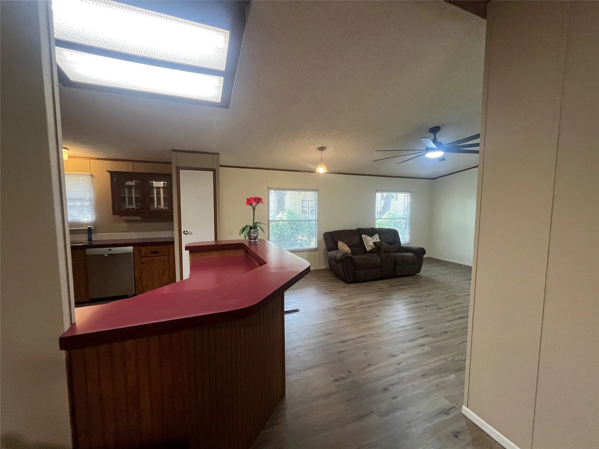 Entry to den/family room from LR with bar and kitchen on left of pic
