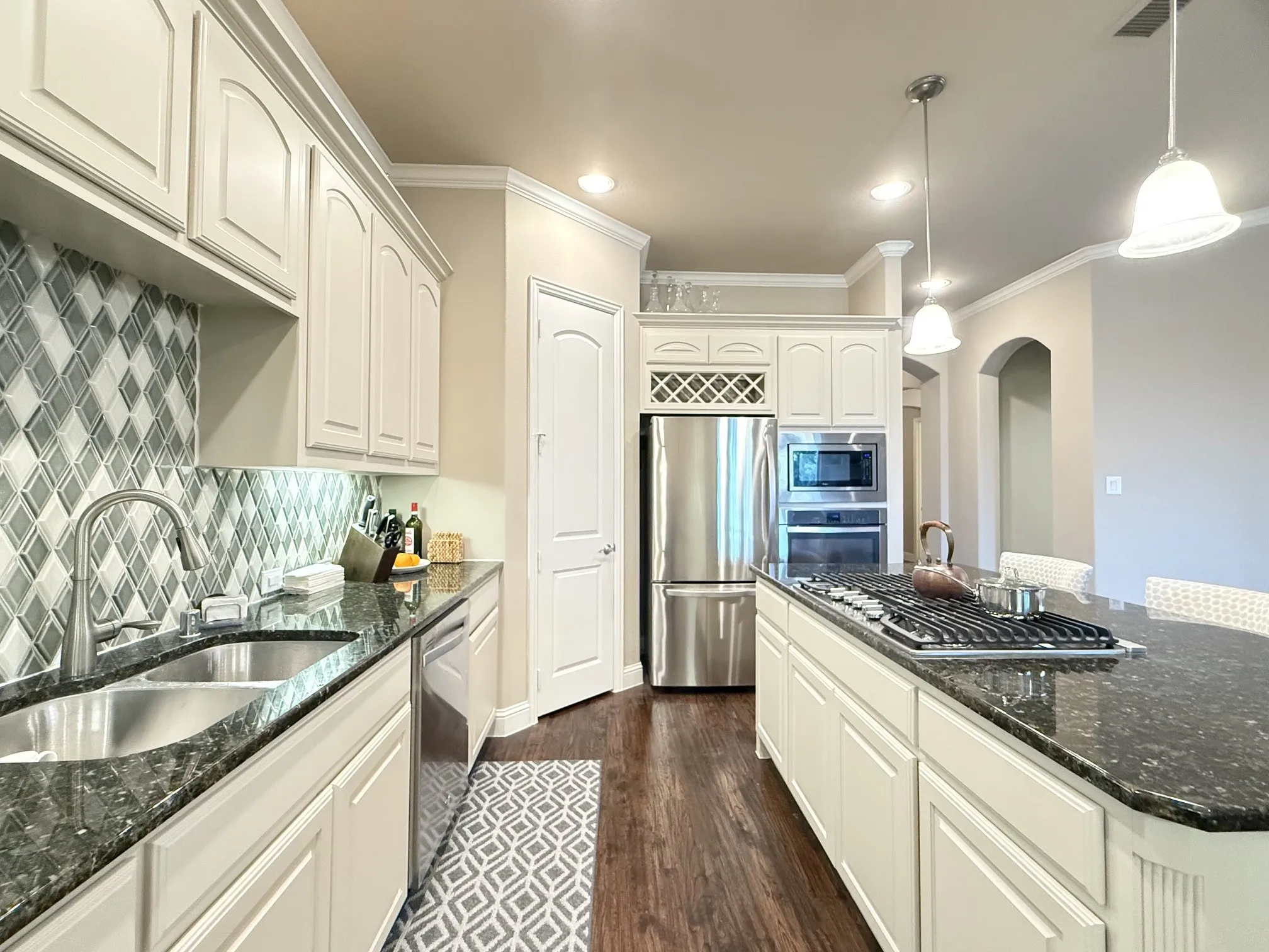Kitchen with built-in wall oven and microwave