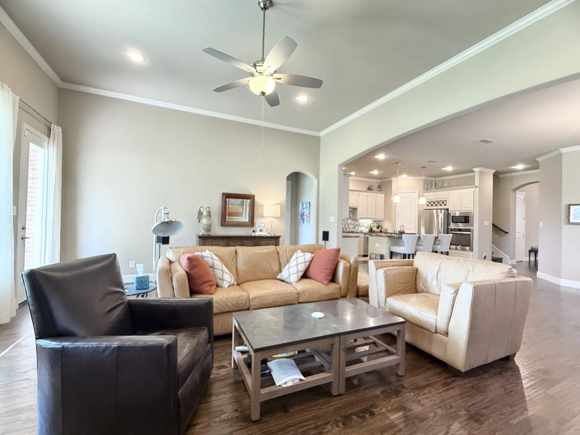 Family room with hand scraped hardwood flooring and ceiling fan