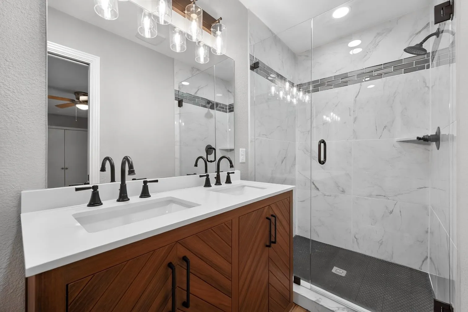 Dual vanity with matte black fixtures and a white countertop