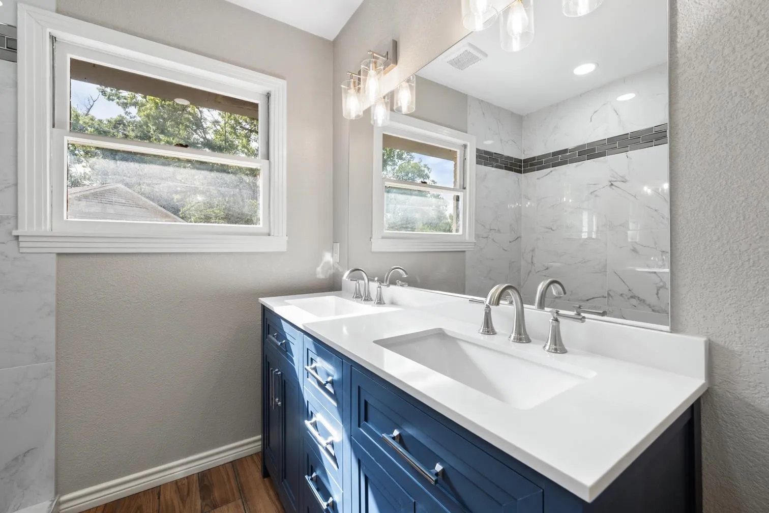 Dual vanity with integrated sinks, white countertop, and brushed nickel fixtures