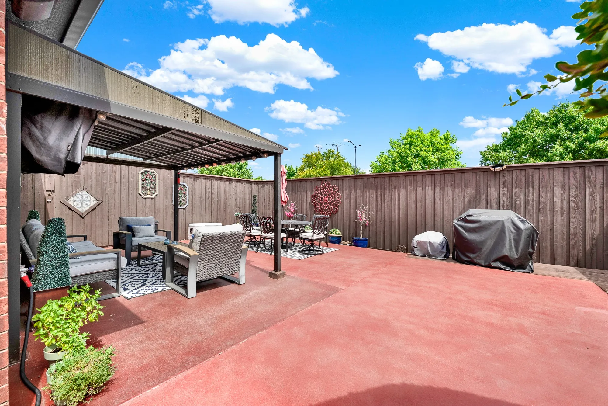 Tall privacy fencing completely encloses the open patio area from every angle. Imagine relaxing in complete seclusion with a cold drink on a breezy summer afternoon.