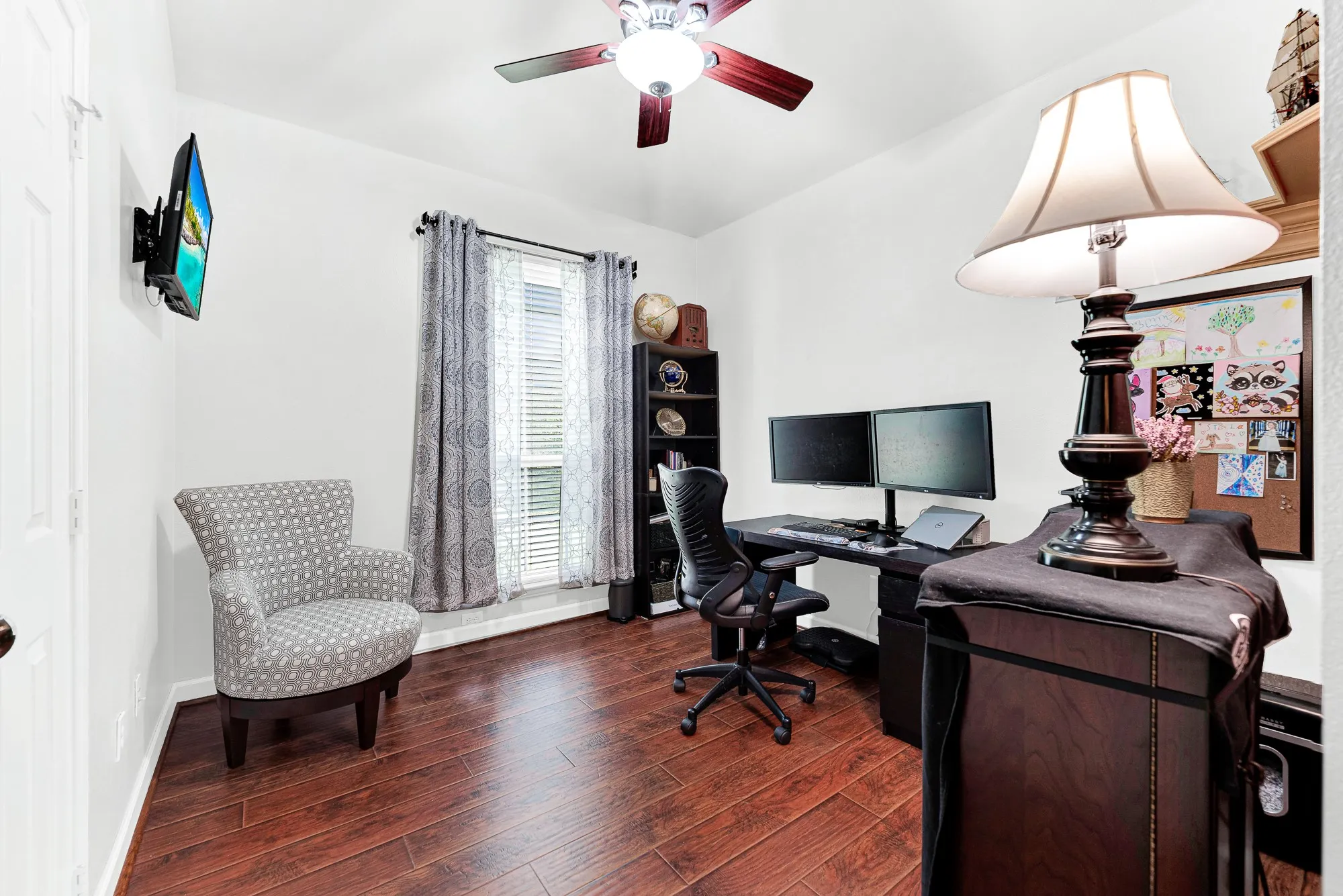 Rich wood floors and clean wall space give this versatile room a bright, focused energy. This guest bedroom can also be a spot for a productive afternoon of remote work before stepping away to enjoy the evening.