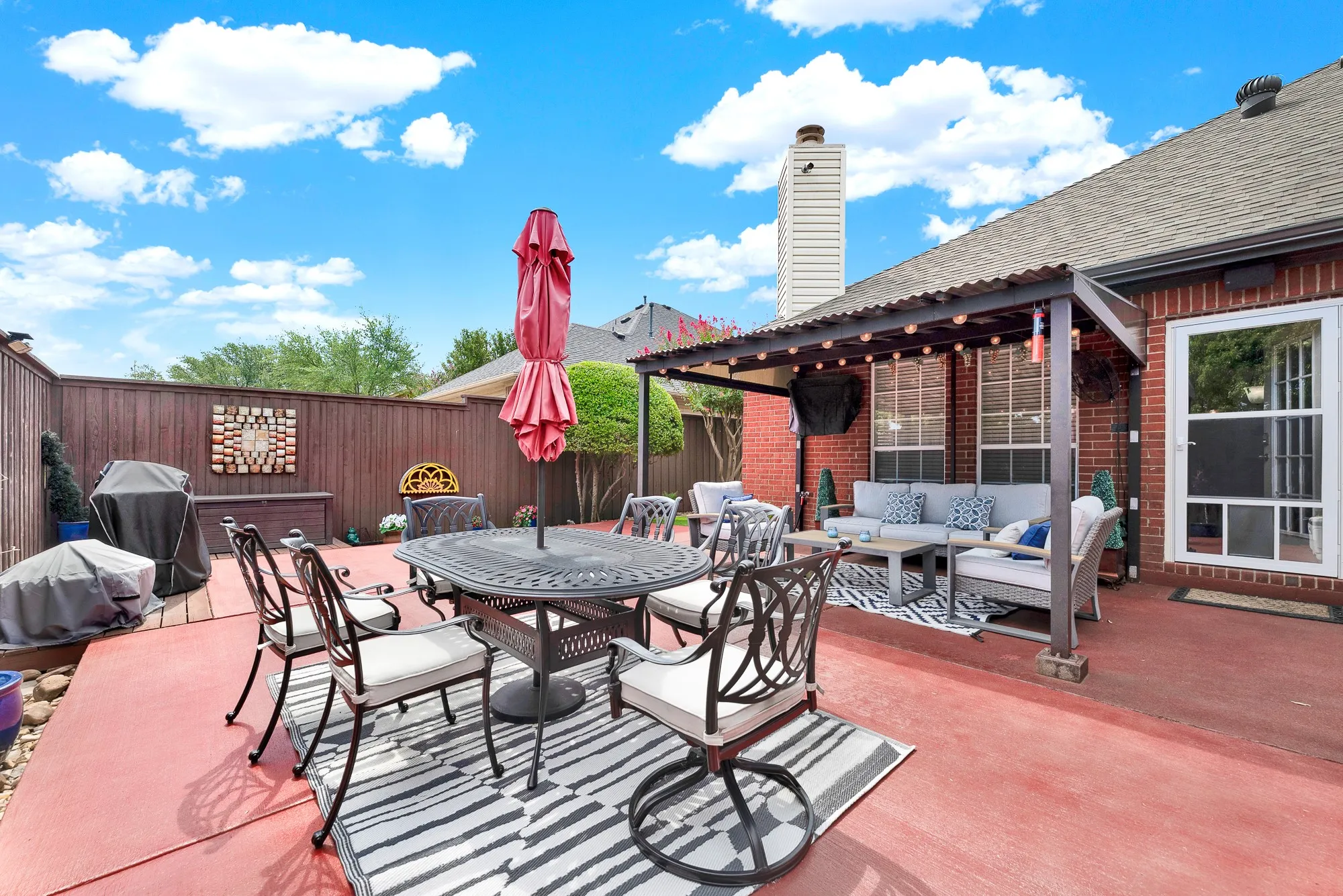 Warm red brick walls meet open sky above a wide, low-maintenance outdoor terrace. Imagine hosting weekend summer barbecues with friends in a private, sun-drenched setting