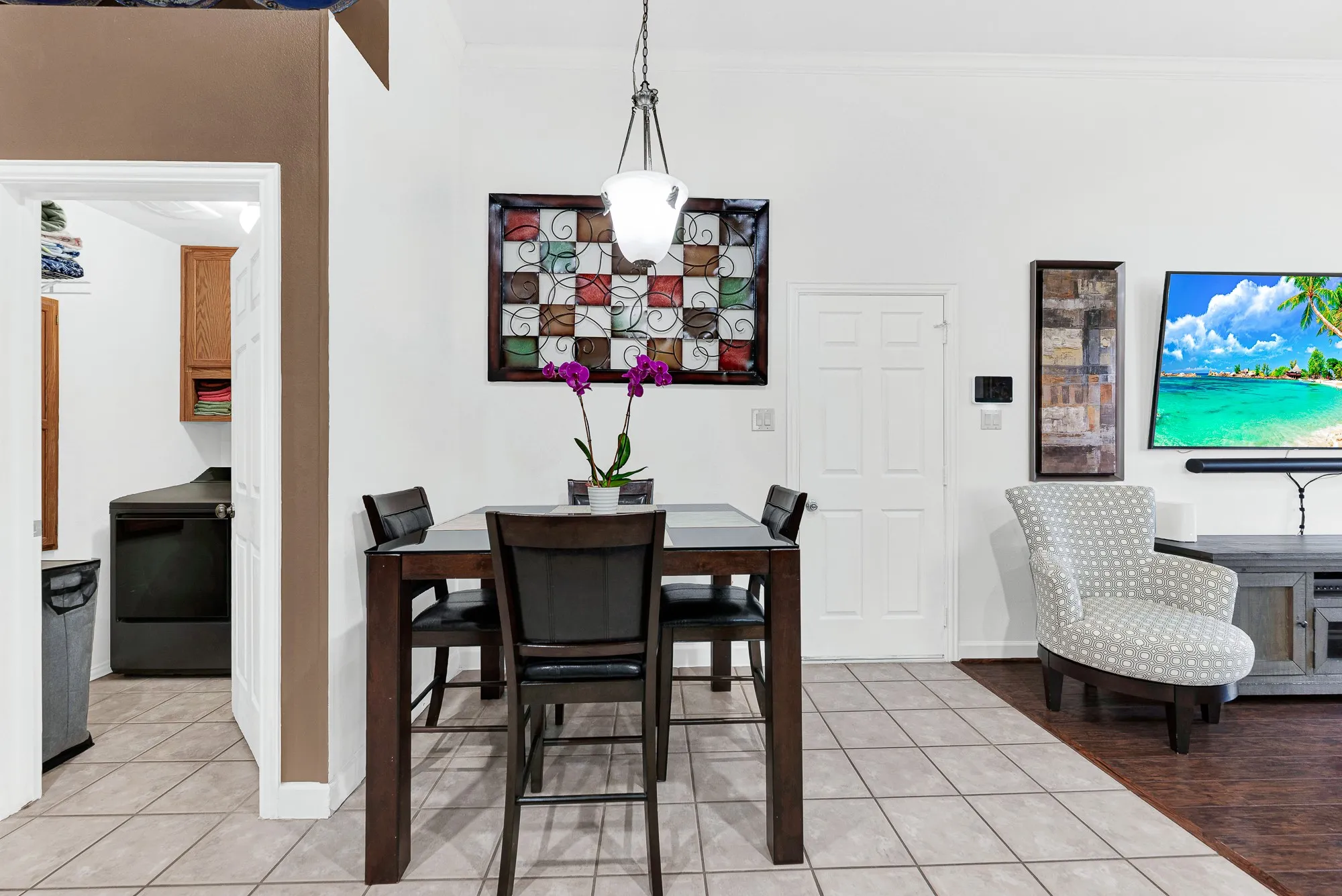 Clean sightlines seamlessly connect the sunny eating nook to both the utility room and main living area. It’s the perfect spot for helping with homework while dinner finishes simmering nearby.