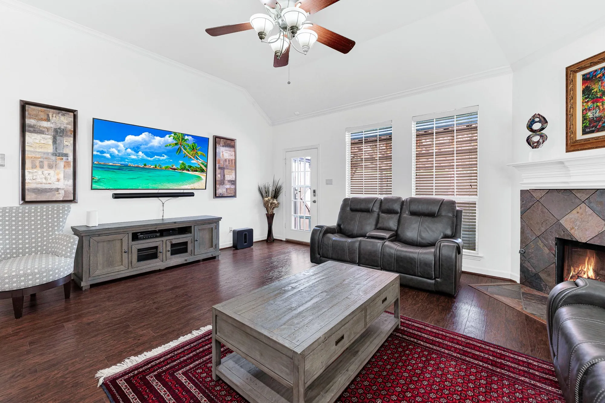 A glass-paneled back door and dual windows flood the main sitting area with gentle afternoon sun. Visualize stepping straight outside into the backyard breeze after relaxing inside on a quiet Sunday afternoon.