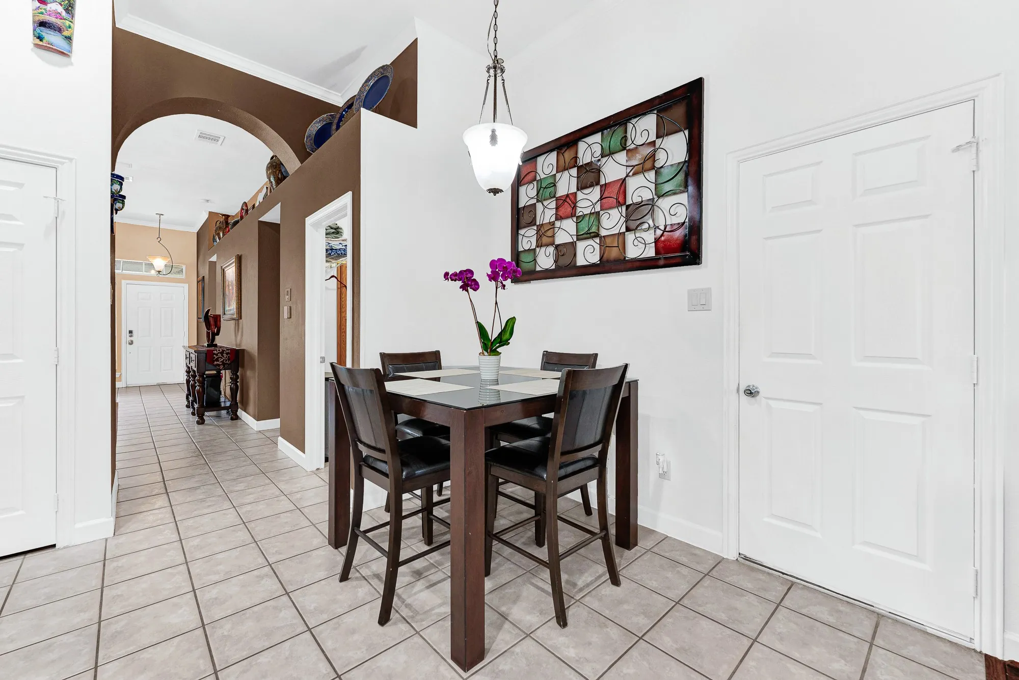 A broad interior archway draws natural light deep into the entry hallway and dining space. Visualize starting your morning right here, enjoying an espresso before stepping out for the day