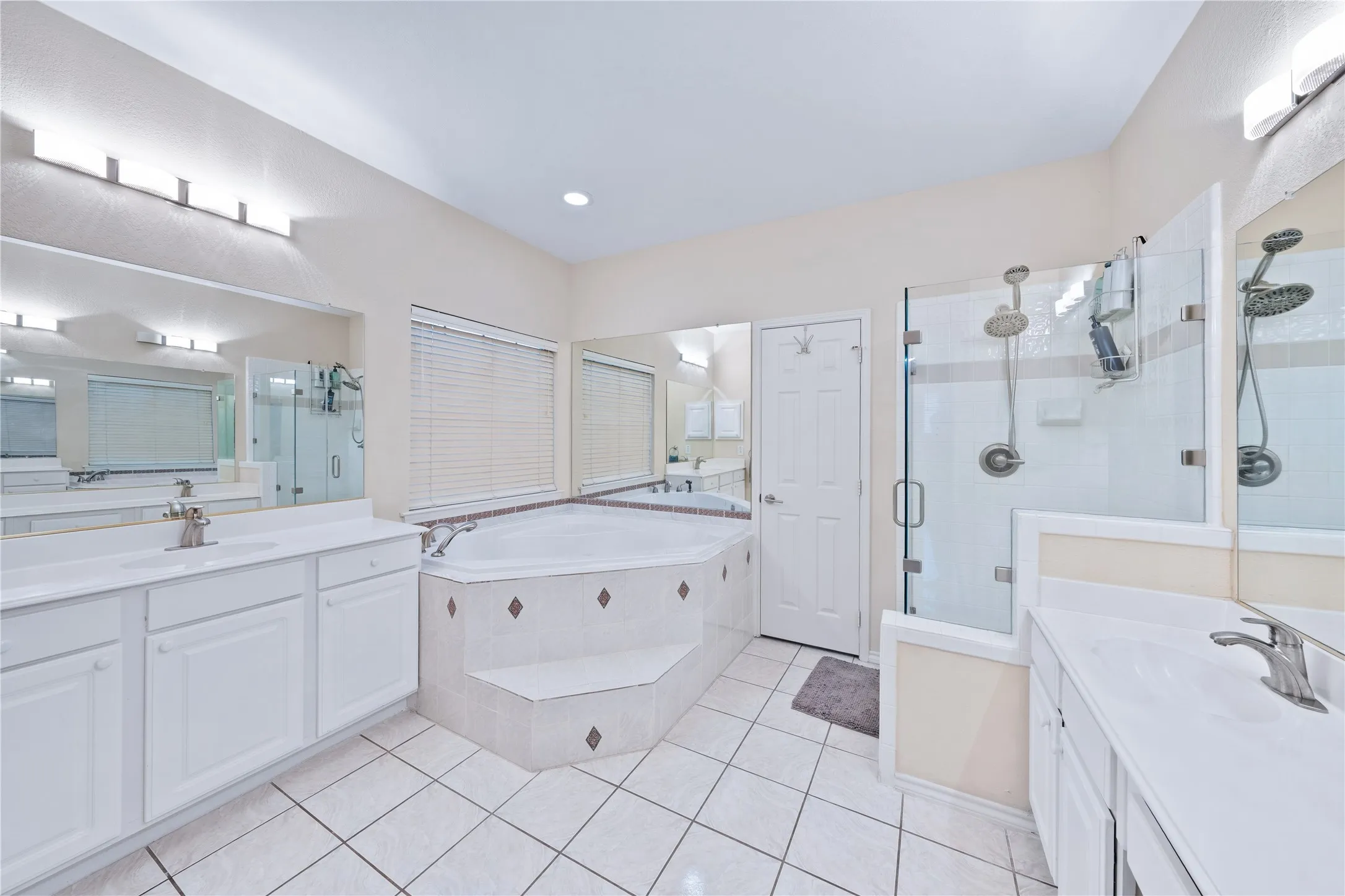 Dual vanity with white cabinetry and integrated sinks