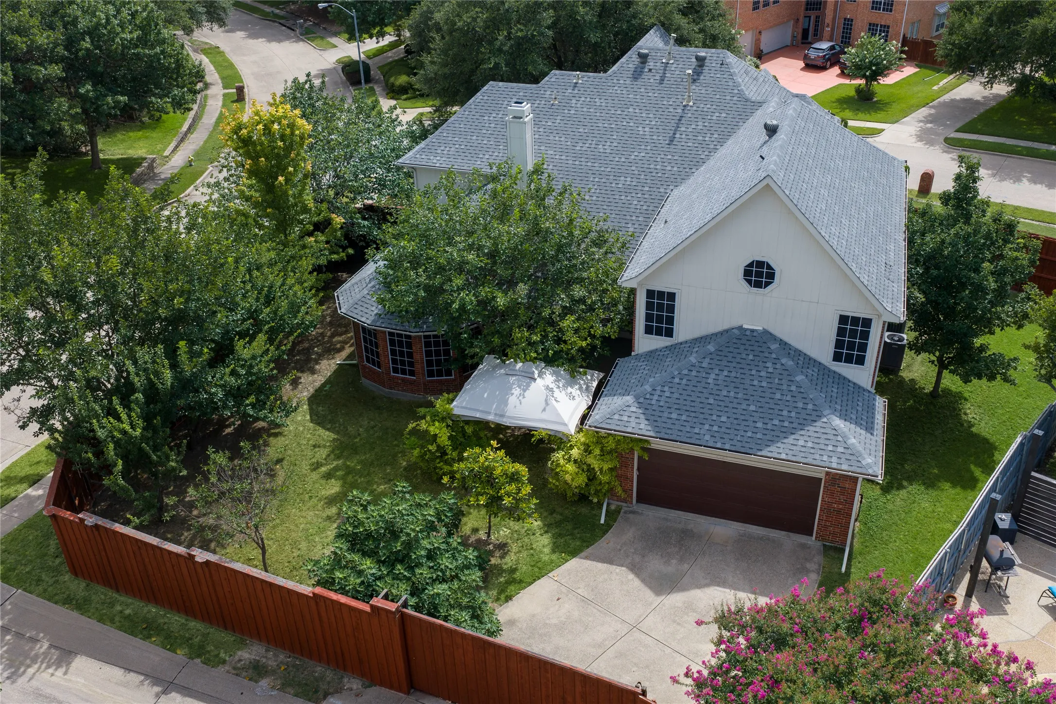Two-story residence featuring a gray shingle roof, white siding, and a prominent front-facing gable