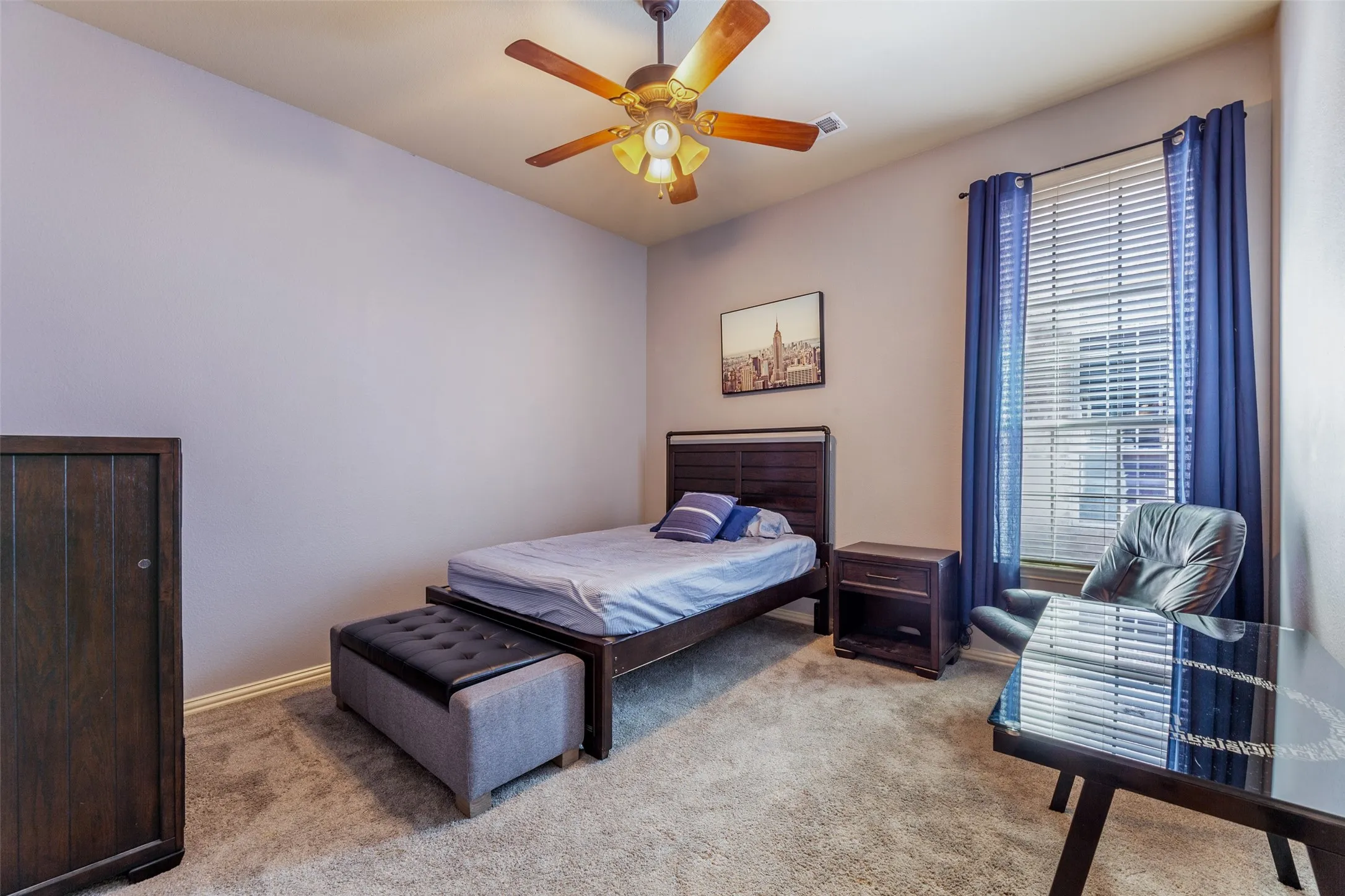 Bedroom featuring baseboards, ceiling fan, and light colored carpet
