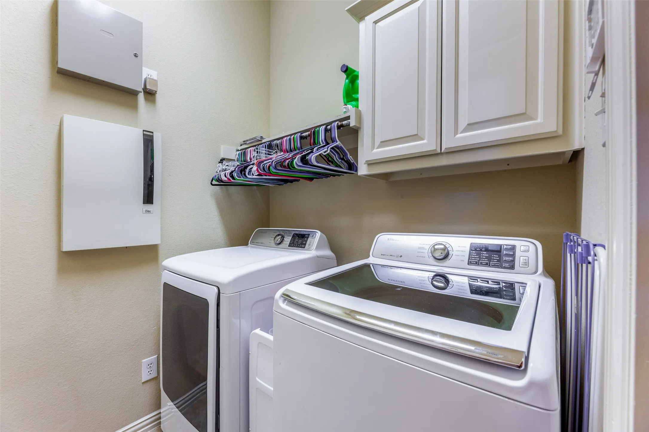 Laundry area featuring washing machine and dryer and cabinet space