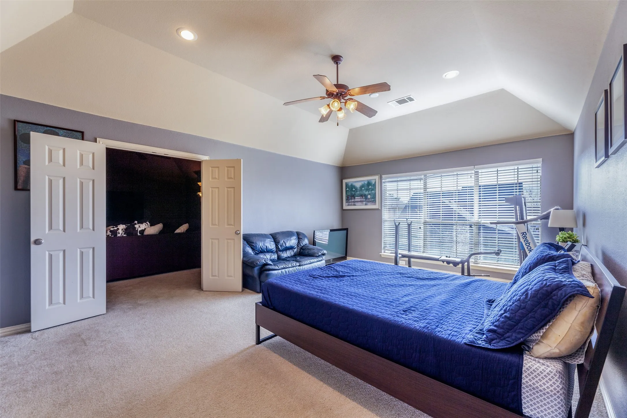 Bedroom featuring recessed lighting, ceiling fan, visible vents, vaulted ceiling, and carpet floors