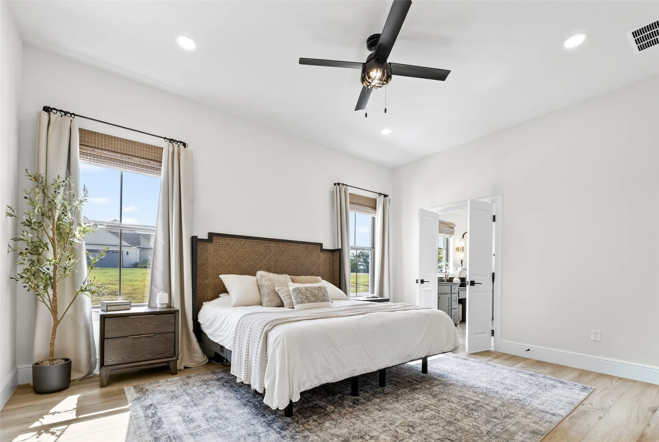 Recessed lighting, ceiling fan, wood-finish flooring, and French doors