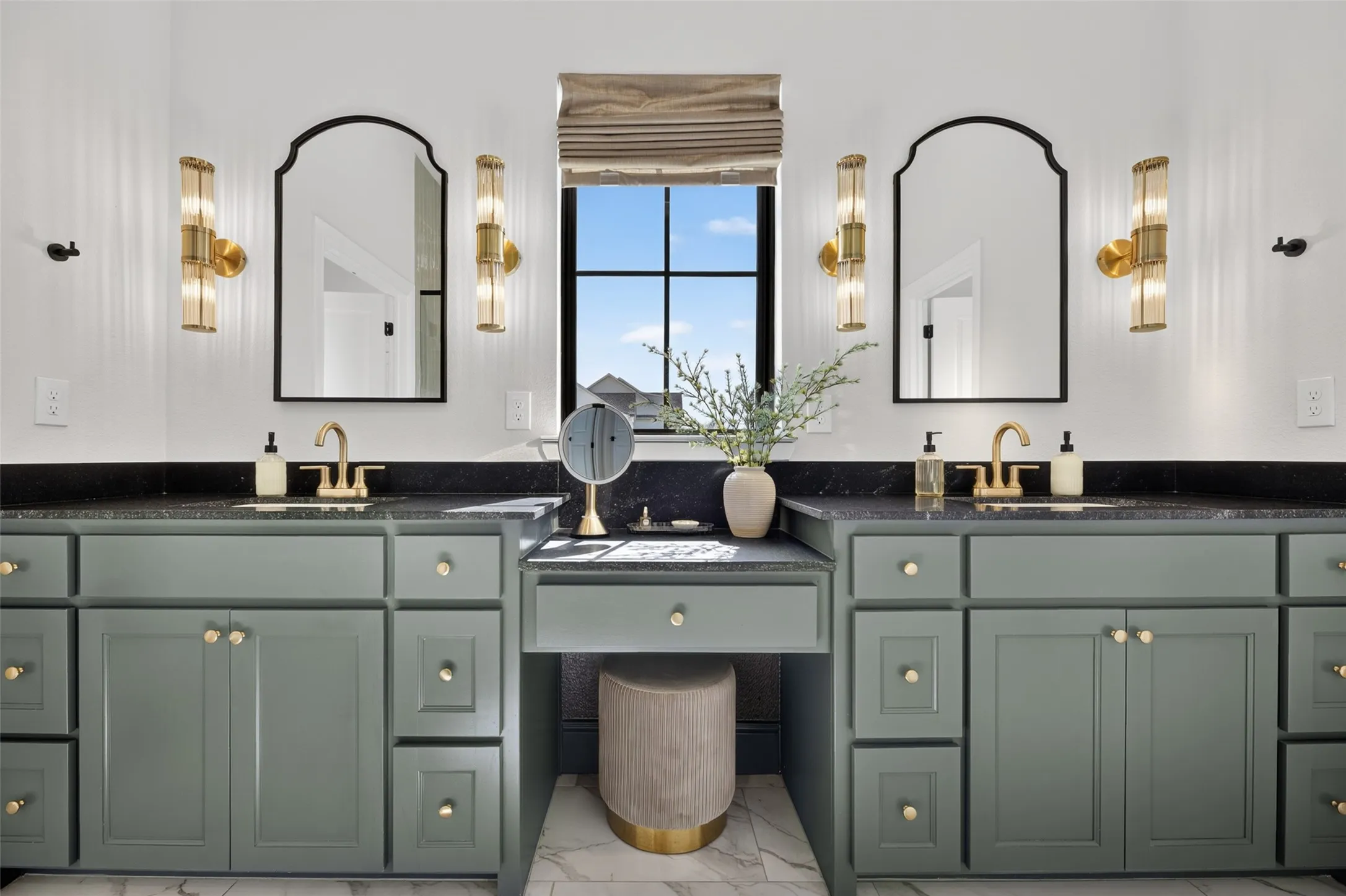 Dual vanity with sage green cabinetry and gold hardware