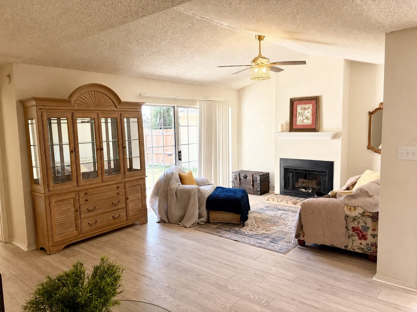 Living room with fireplace and sliding door to private yard.
