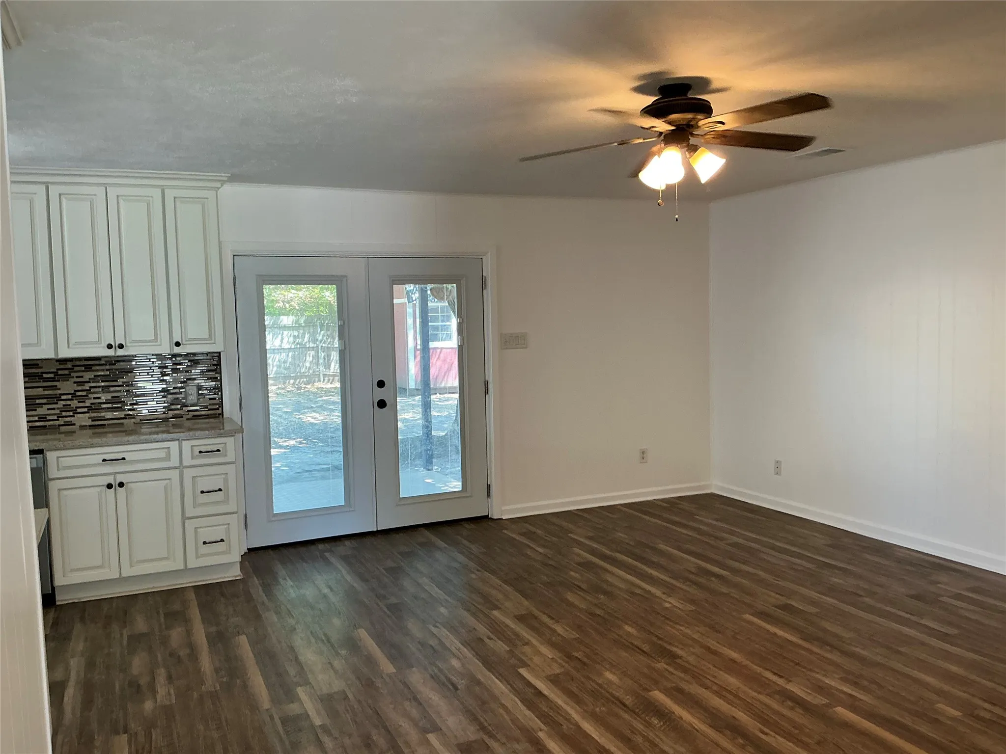 French doors lead to covered back porch