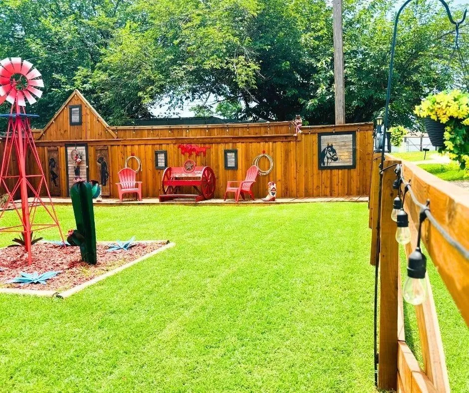 Side of Front yard featuring yard art and fencing
