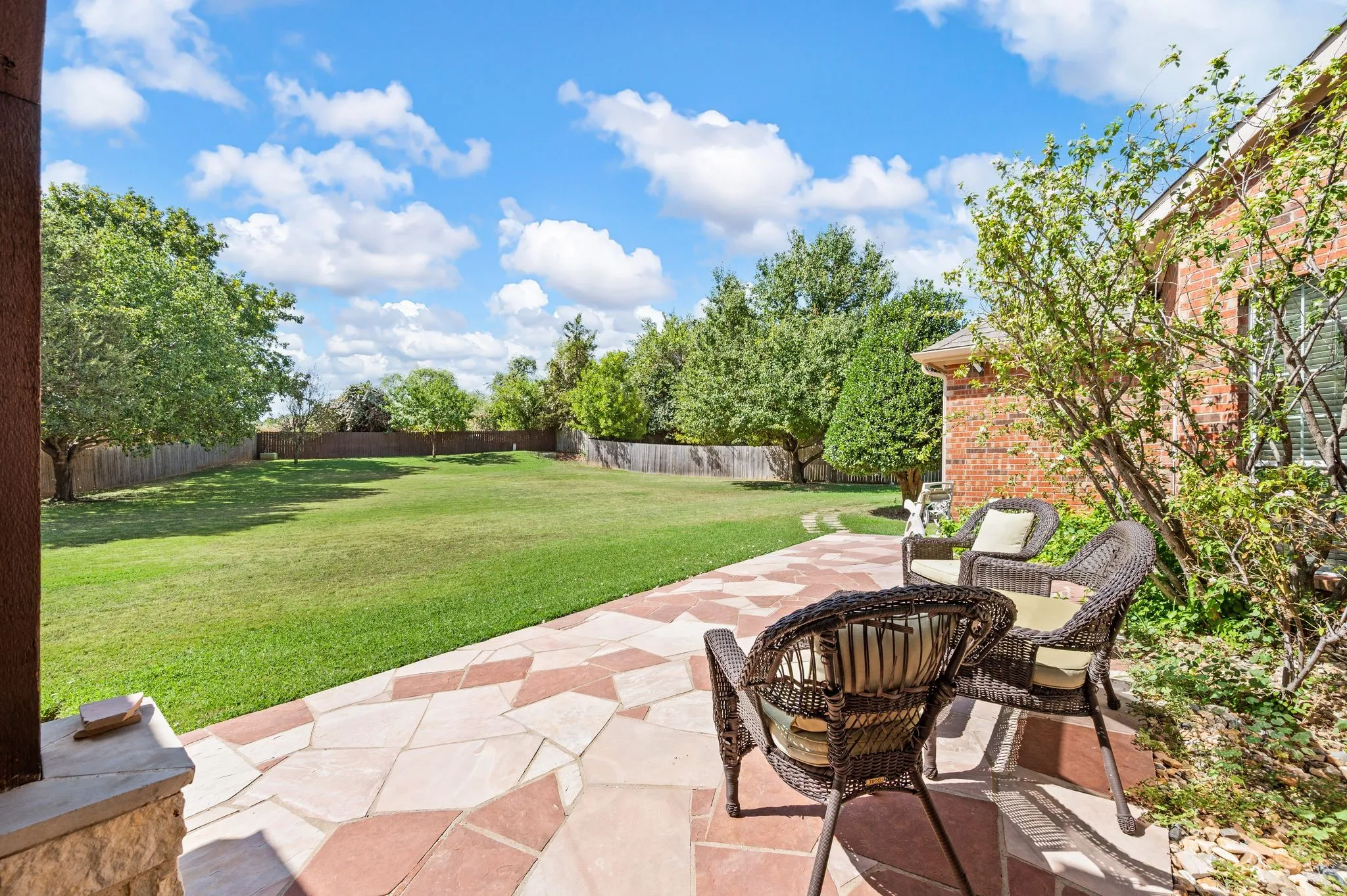 Expansive green space with a wood fence perimeter