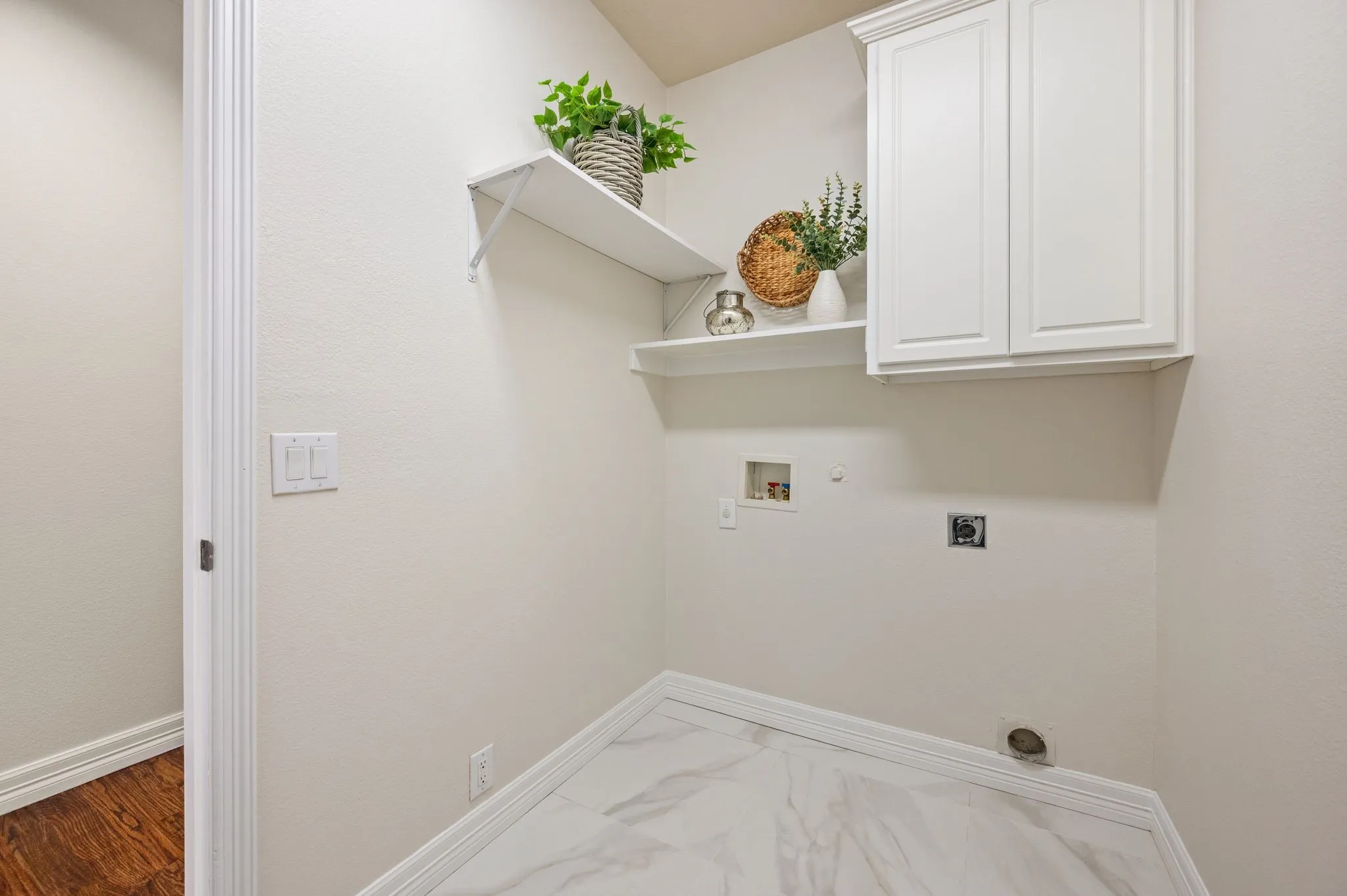 White shaker-style cabinetry, open shelving, and light-toned walls