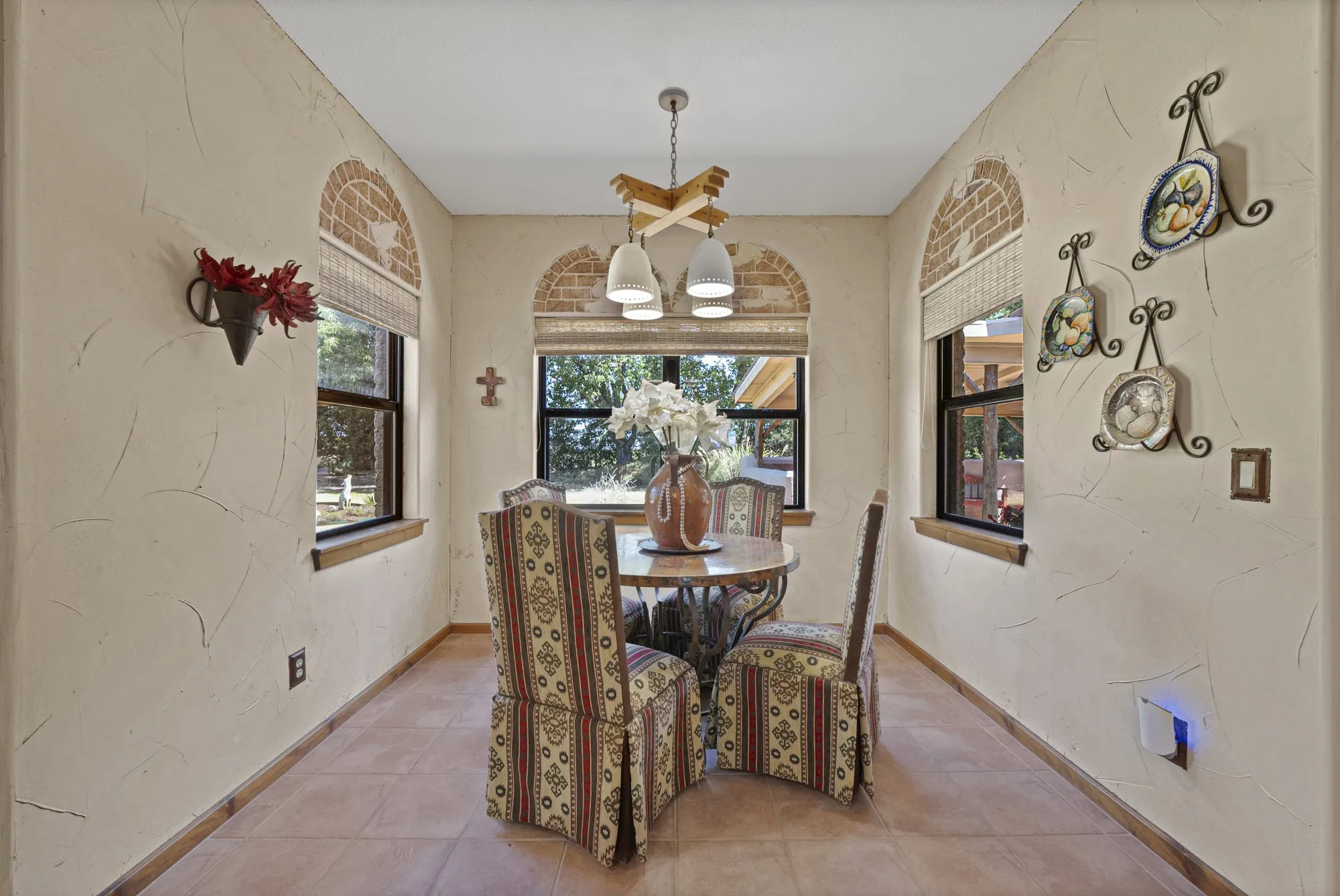 Breakfast nook with southwestern brick-wall enlays and views of the large backyard.