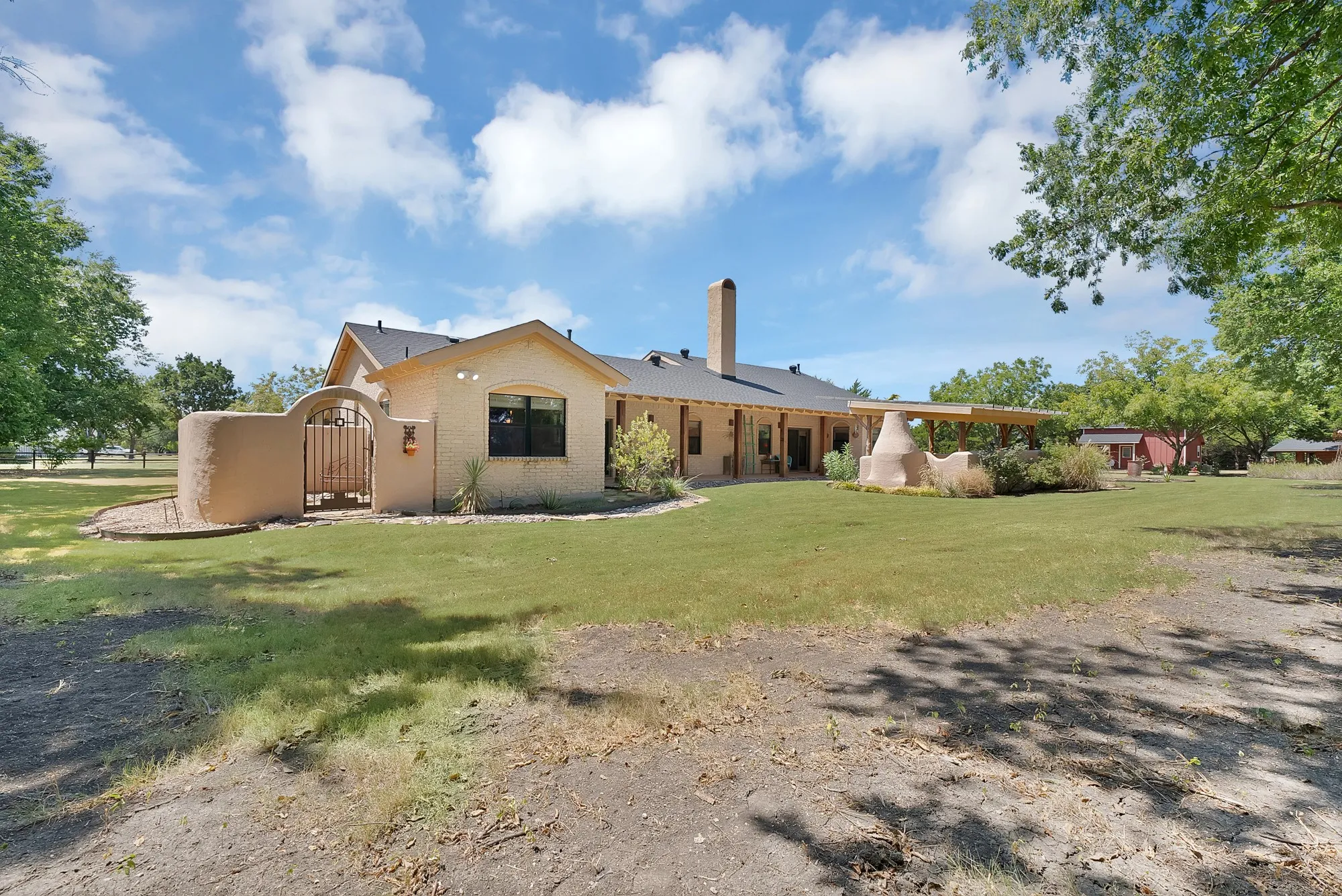 View of backyard with private side courtyard behind the gate.