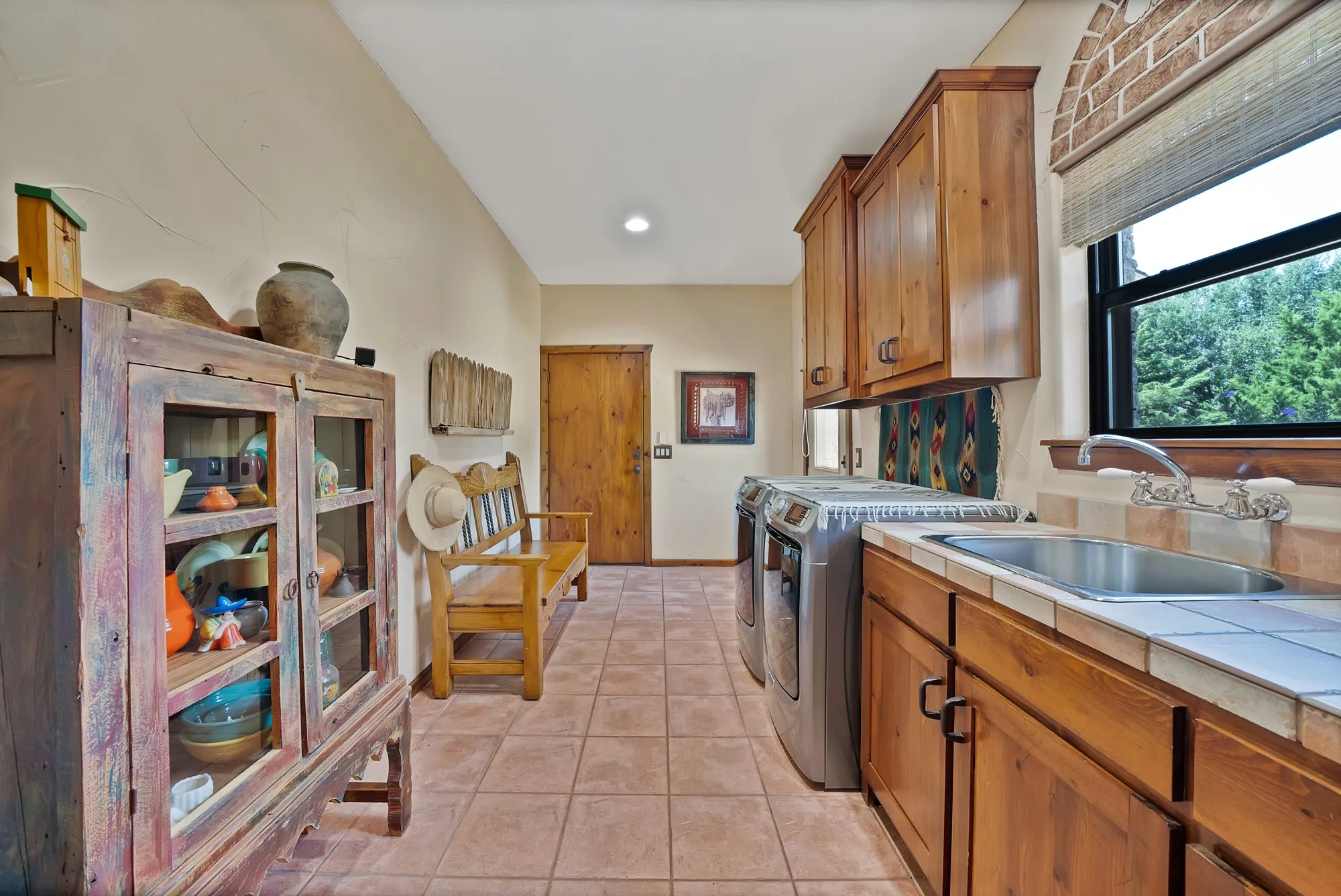 Utility room with mud hall, utility sink, exterior door to side yard and door to garage. Plenty of space for additional fridge, freezer.