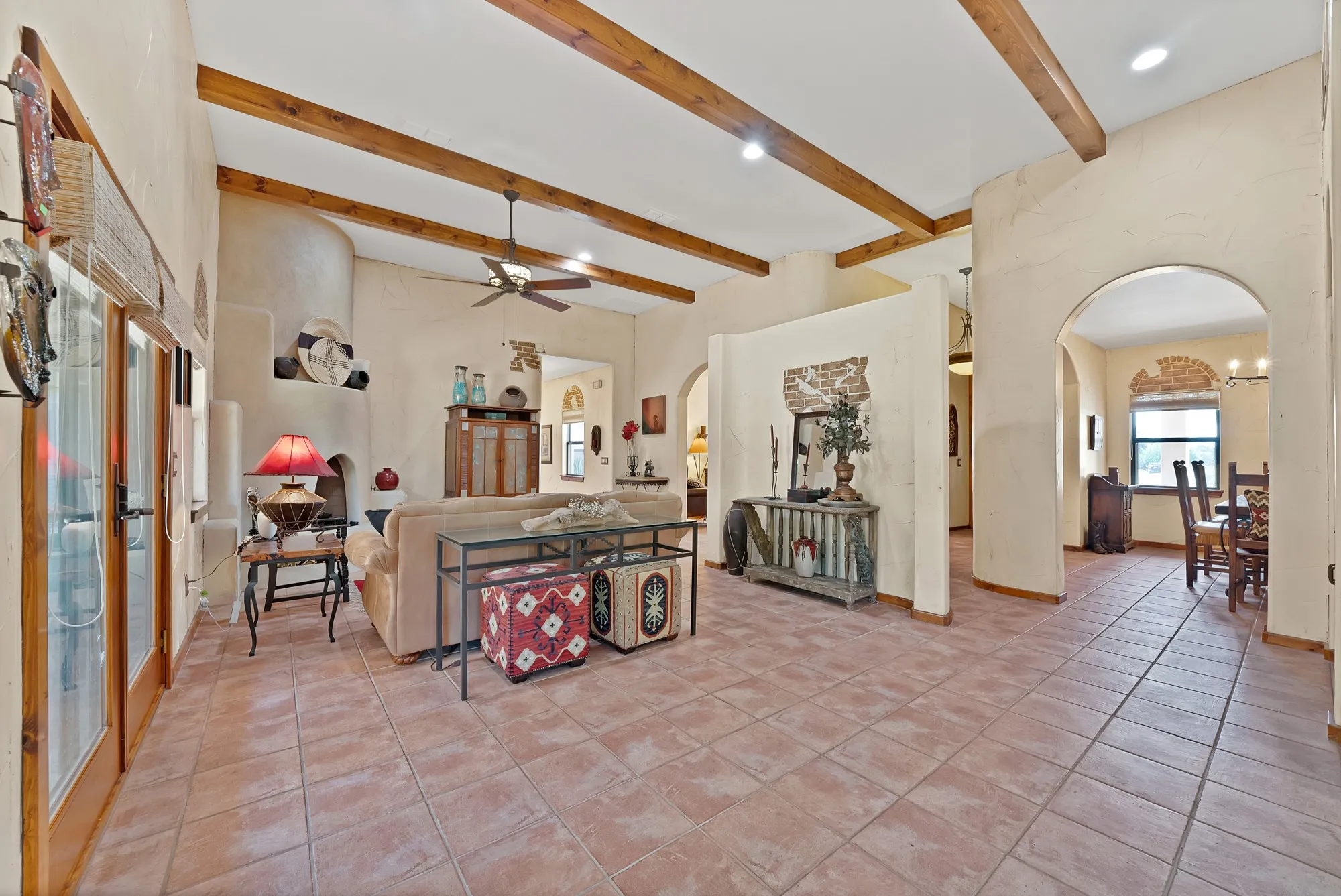 Family room with beautiful ceiling beams looking towards the dining room and hallway.