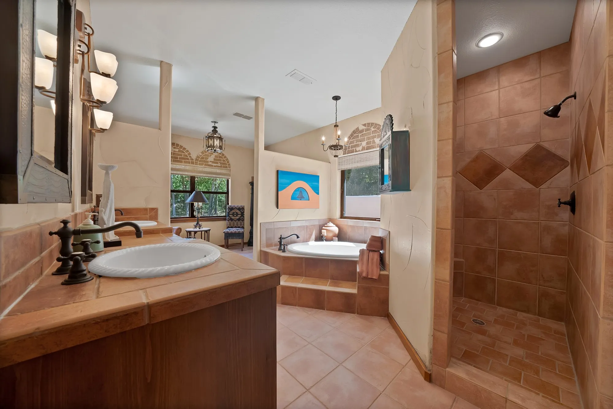 Primary bathroom with large walk-in shower, separate tub and sitting room to enjoy morning coffee.