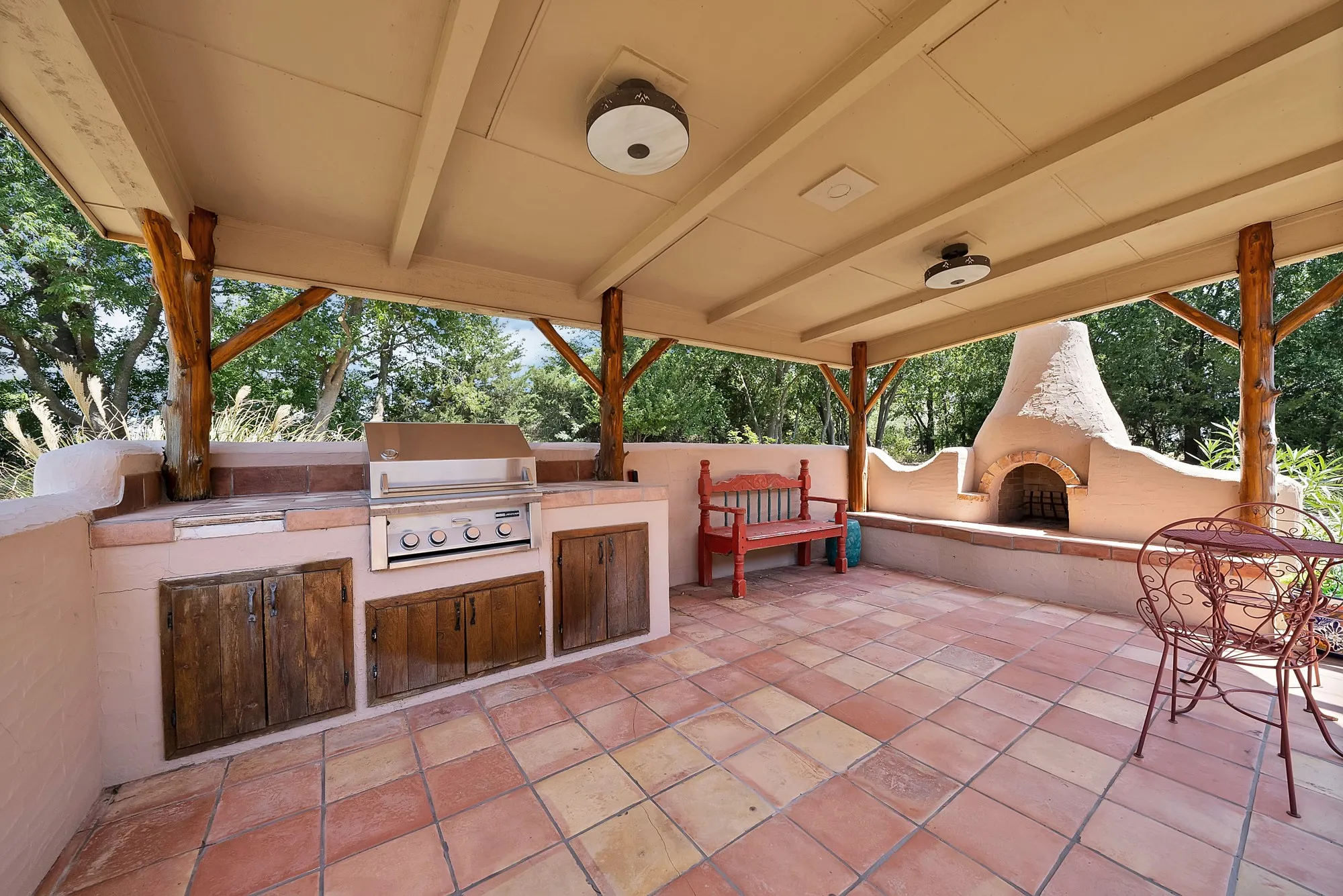 Built-in grill area, dining space and fireplace.