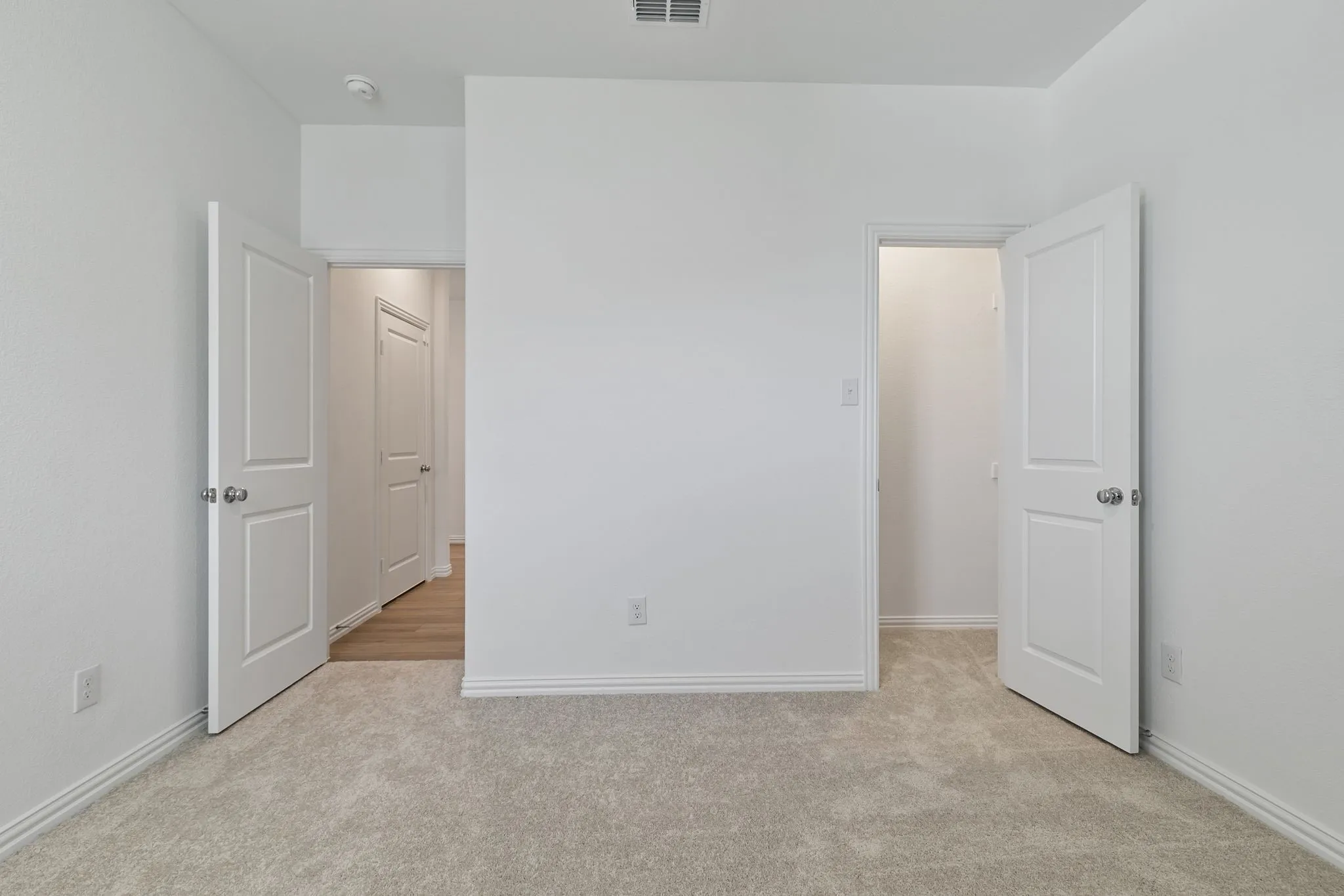 Unfurnished bedroom featuring light carpet