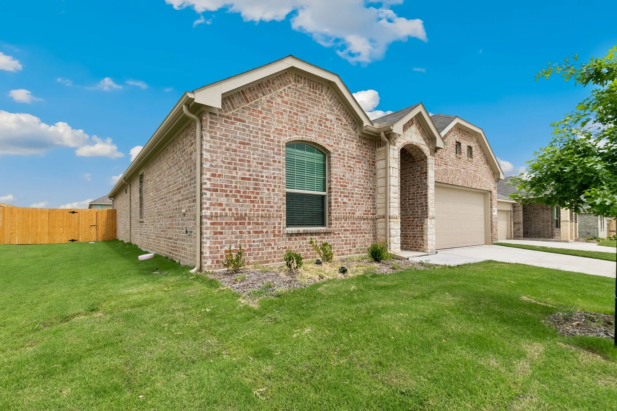 View of front of house with a front lawn and a garage