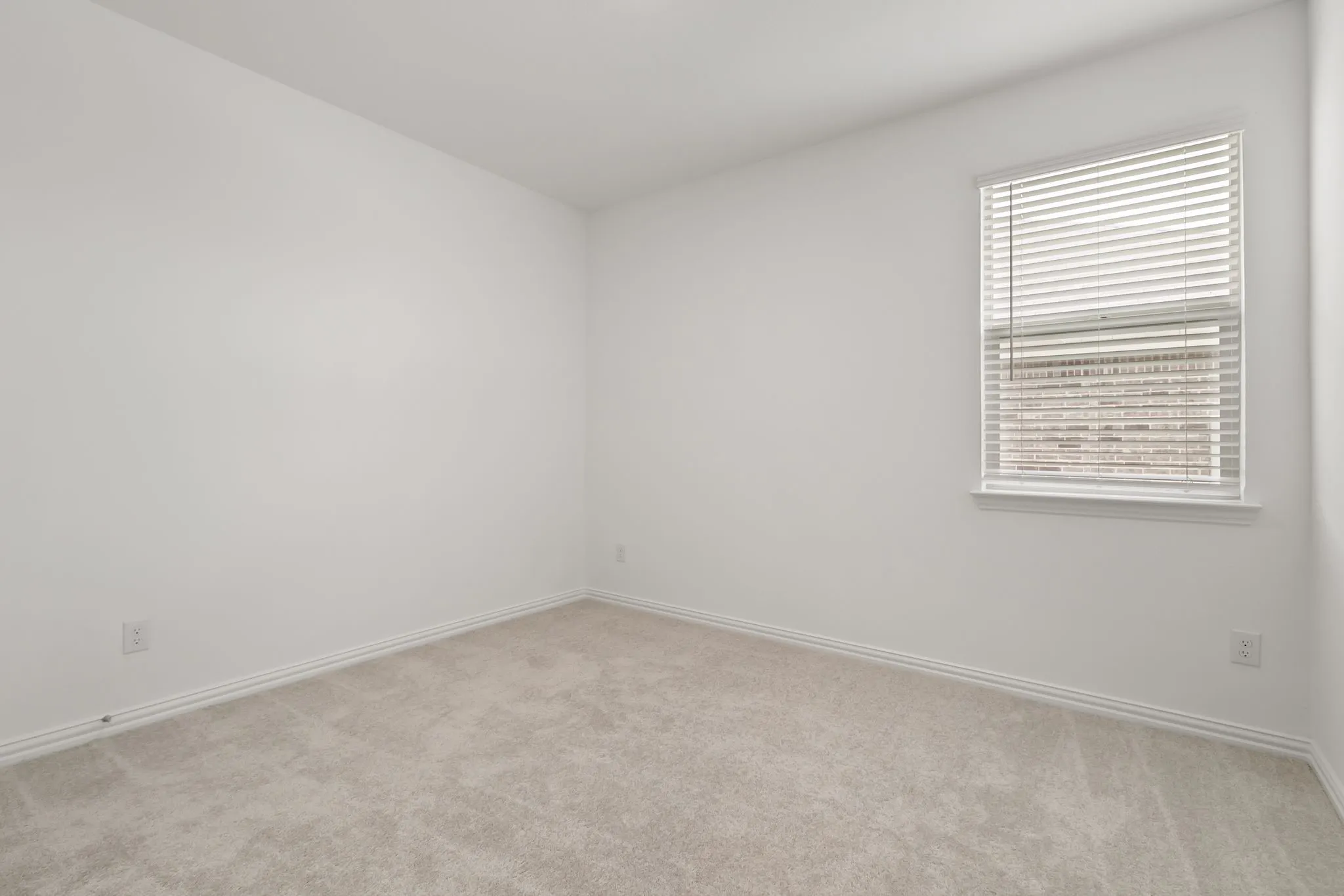 Spare room featuring light carpet