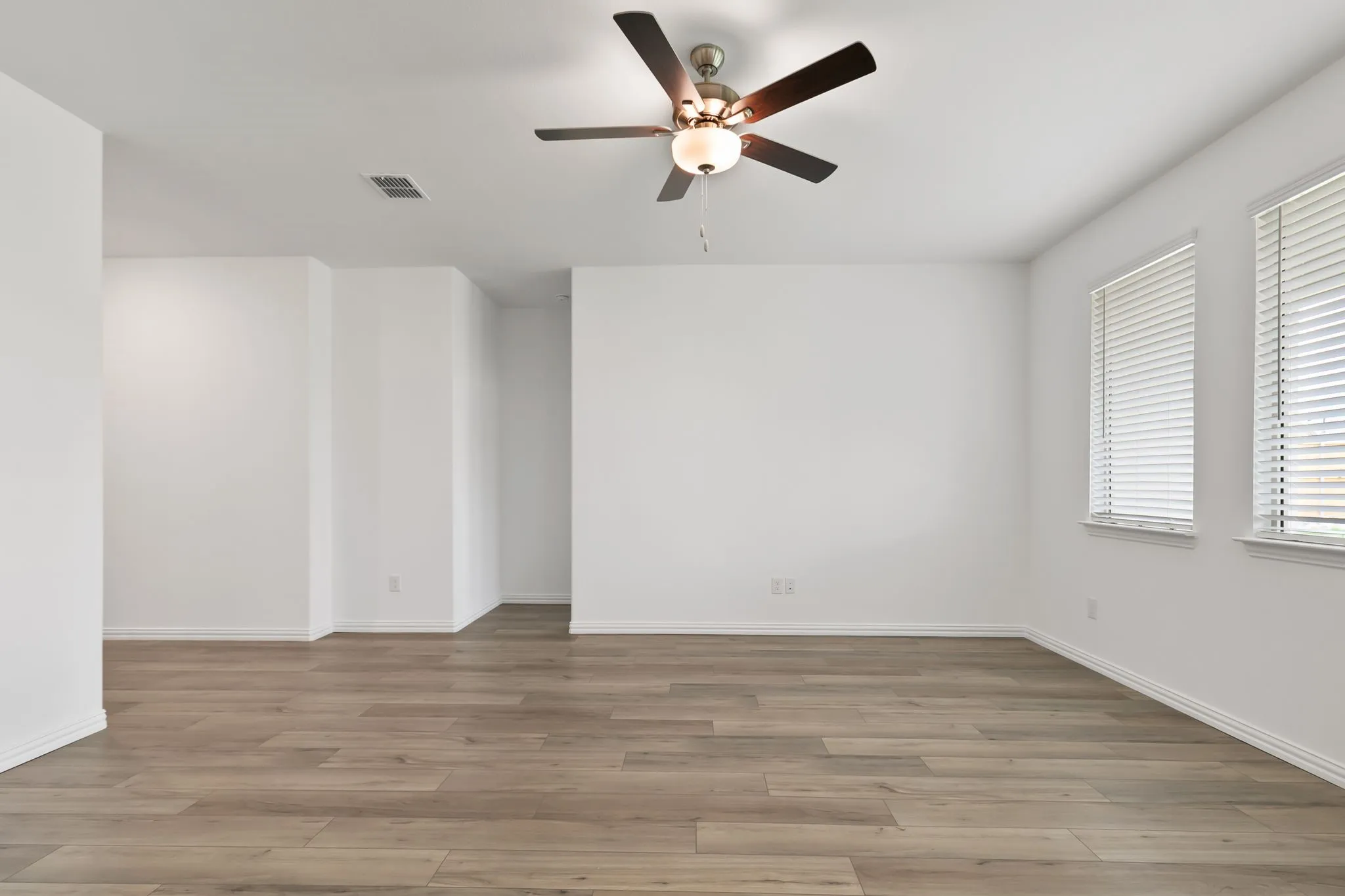Spare room featuring ceiling fan and hardwood / wood-style flooring