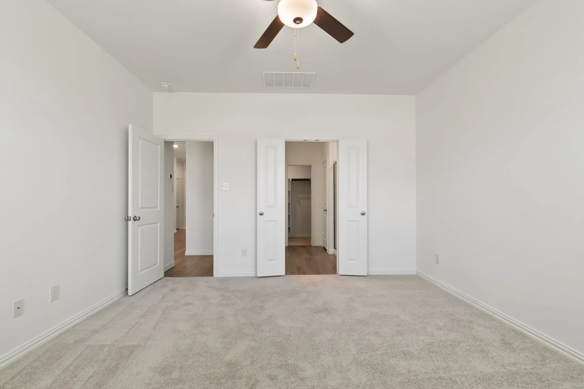 Unfurnished bedroom featuring ceiling fan and carpet floors