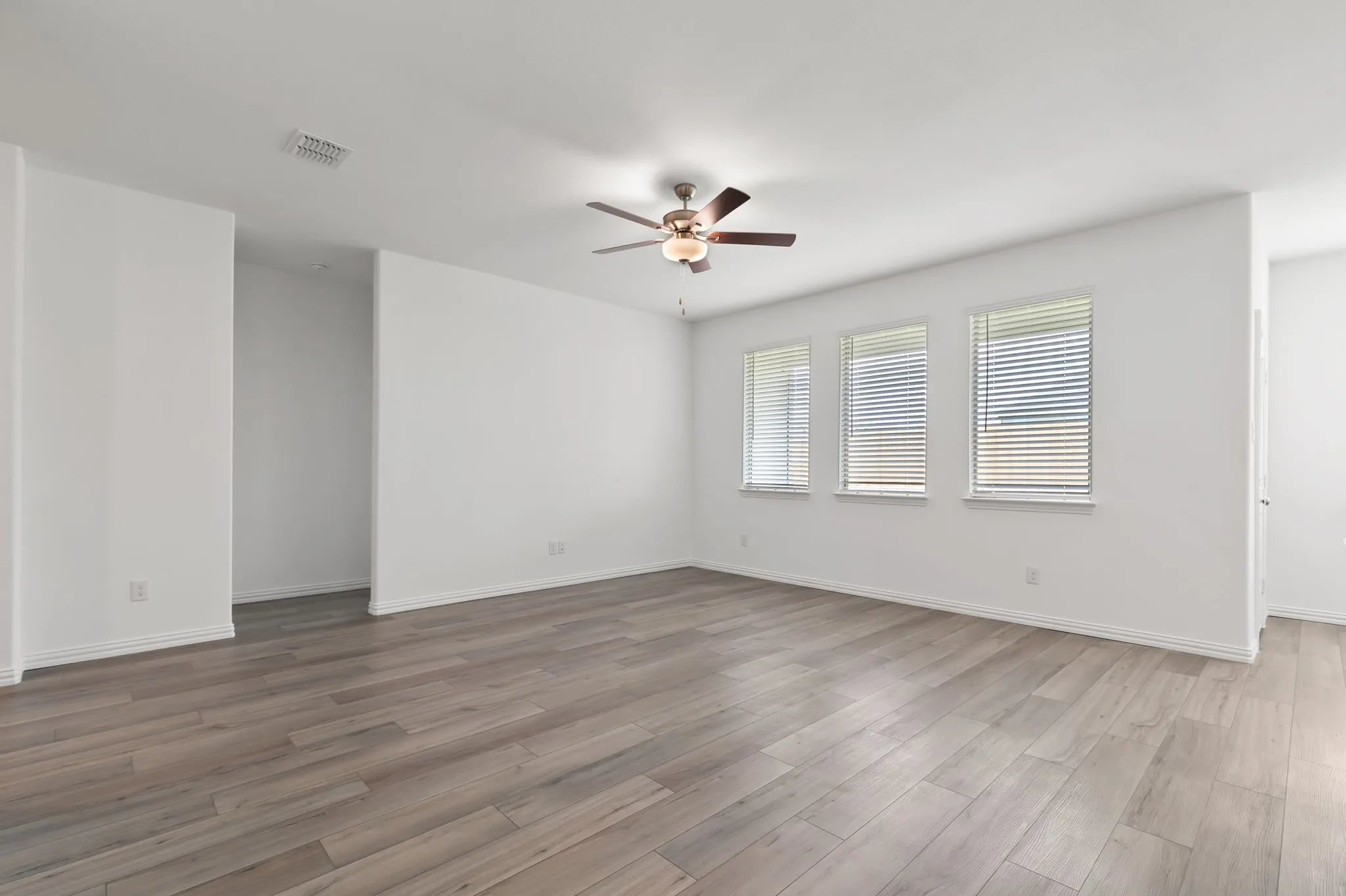Spare room featuring dark hardwood / wood-style flooring and ceiling fan