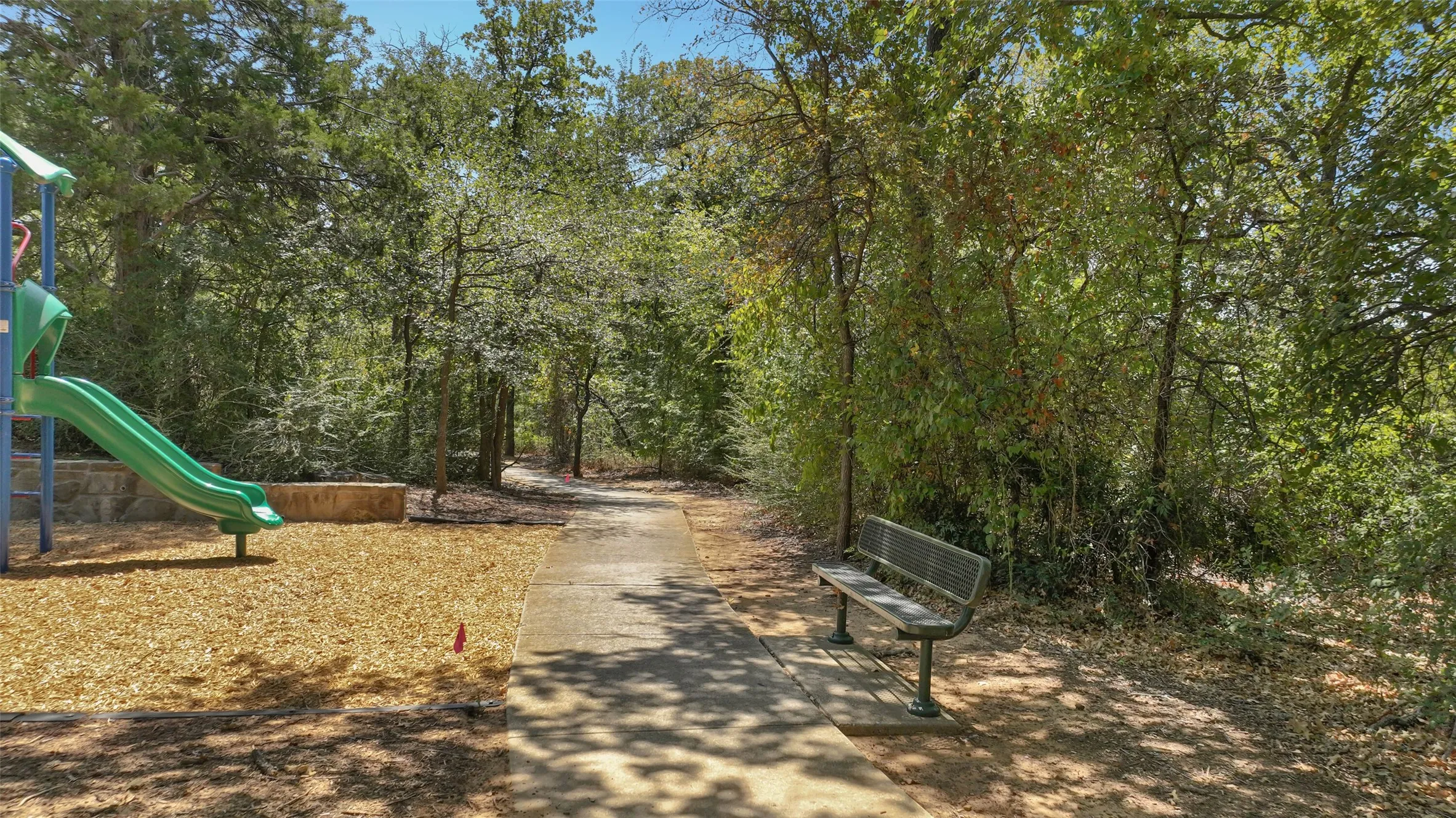 Neighborhood walking trail through the shade of the trees