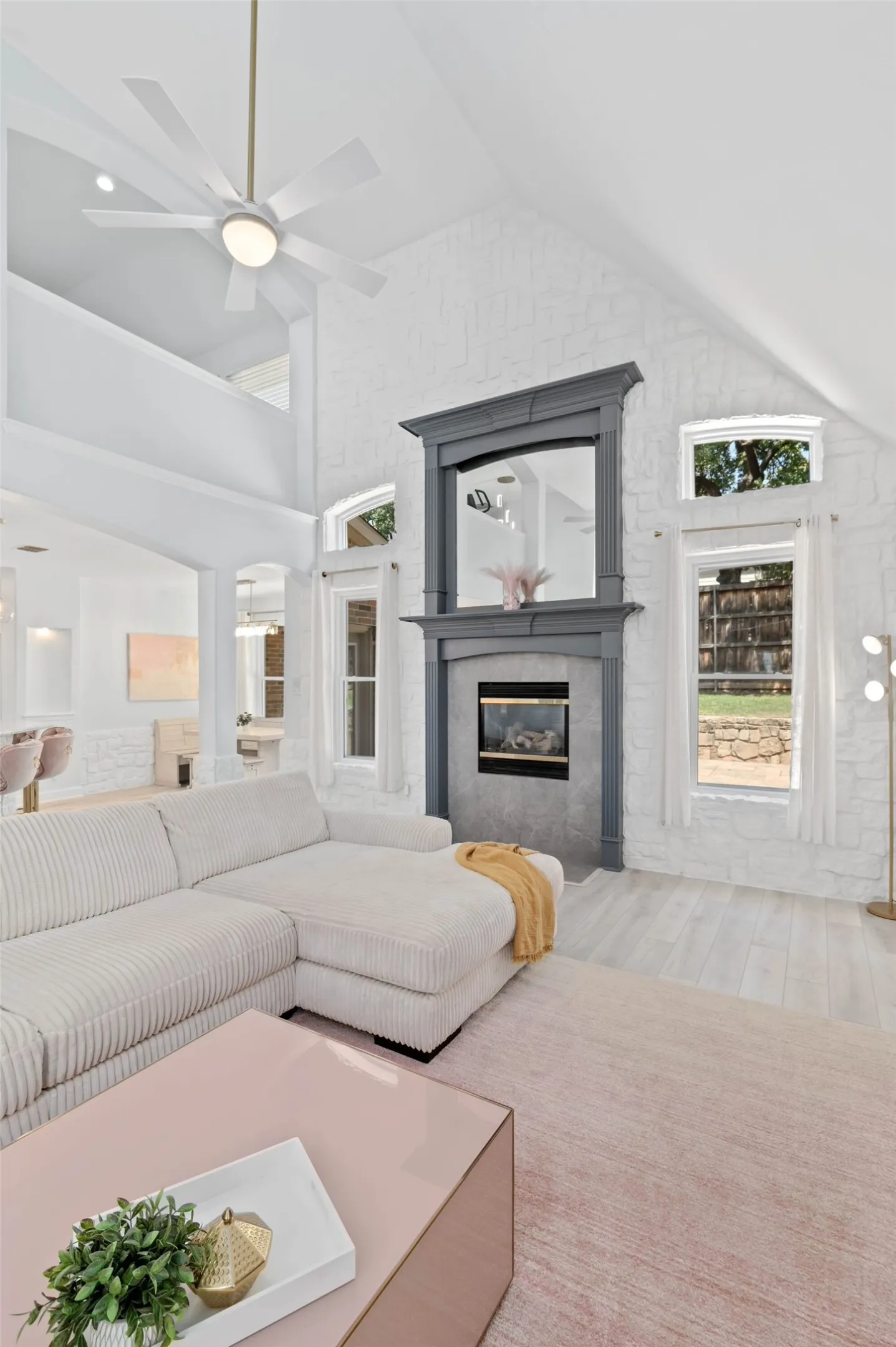 The cathedral ceiling in the living room is perfectly suited for the floor to ceiling fireplace and stonework surround.