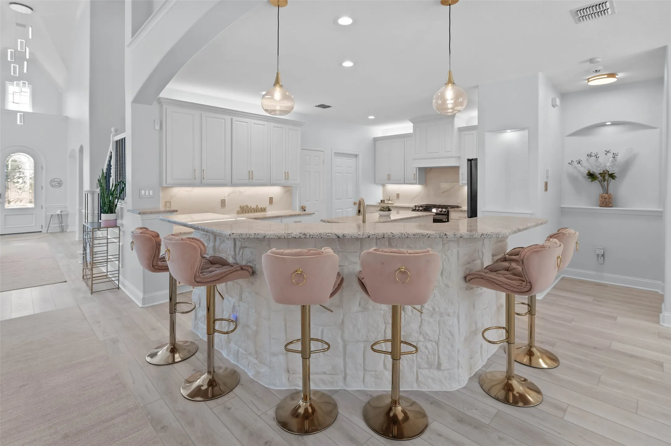 Large kitchen with breakfast bar, two islands with granite counters and a multitude of work space