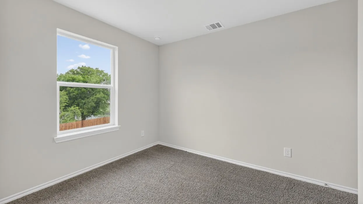 Neutral-toned walls complement the gray carpeting